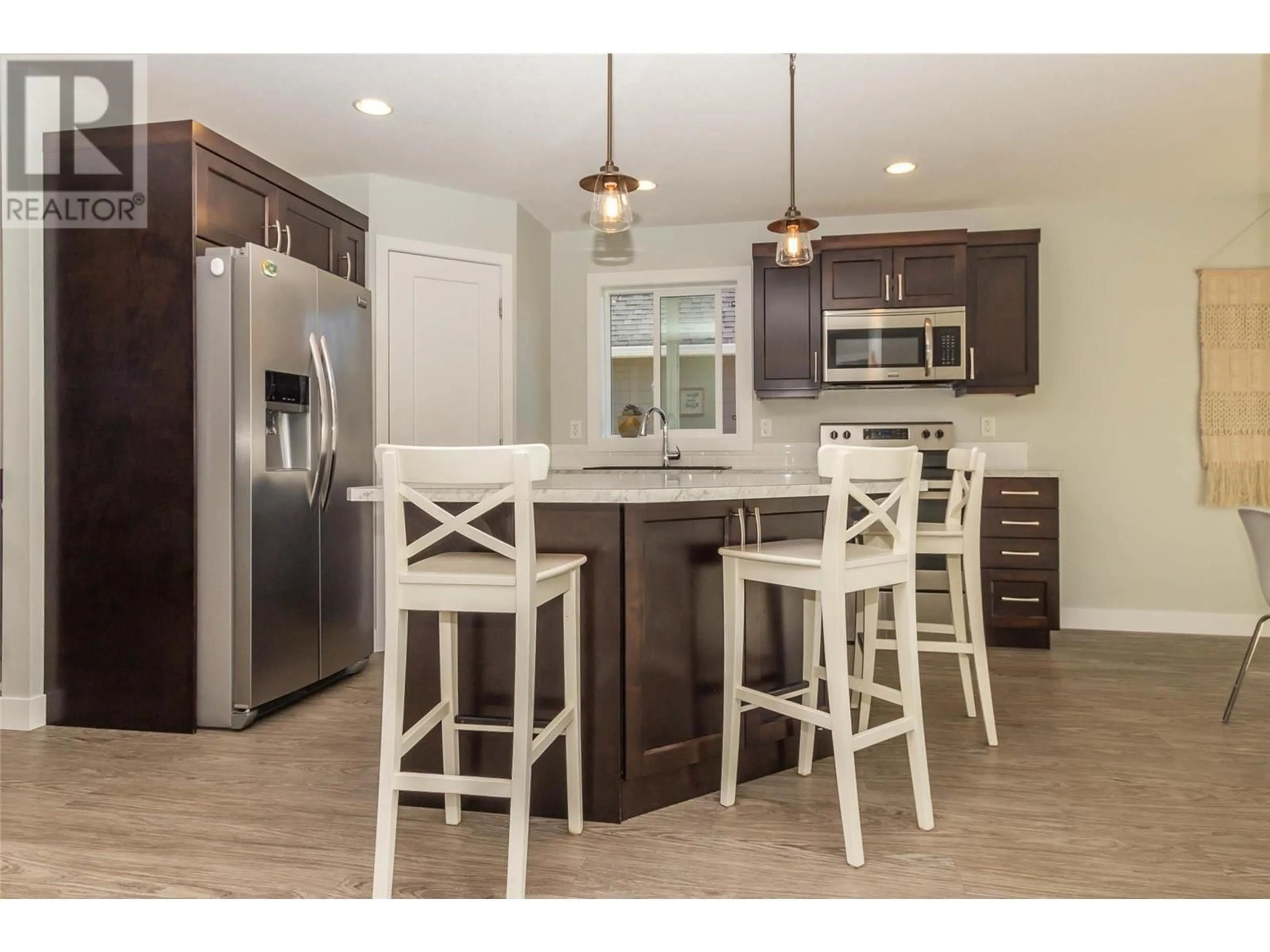 Open concept kitchen, wood/laminate floor for 2368 4B AVENUE SOUTHEAST, Salmon Arm British Columbia V1E1K9