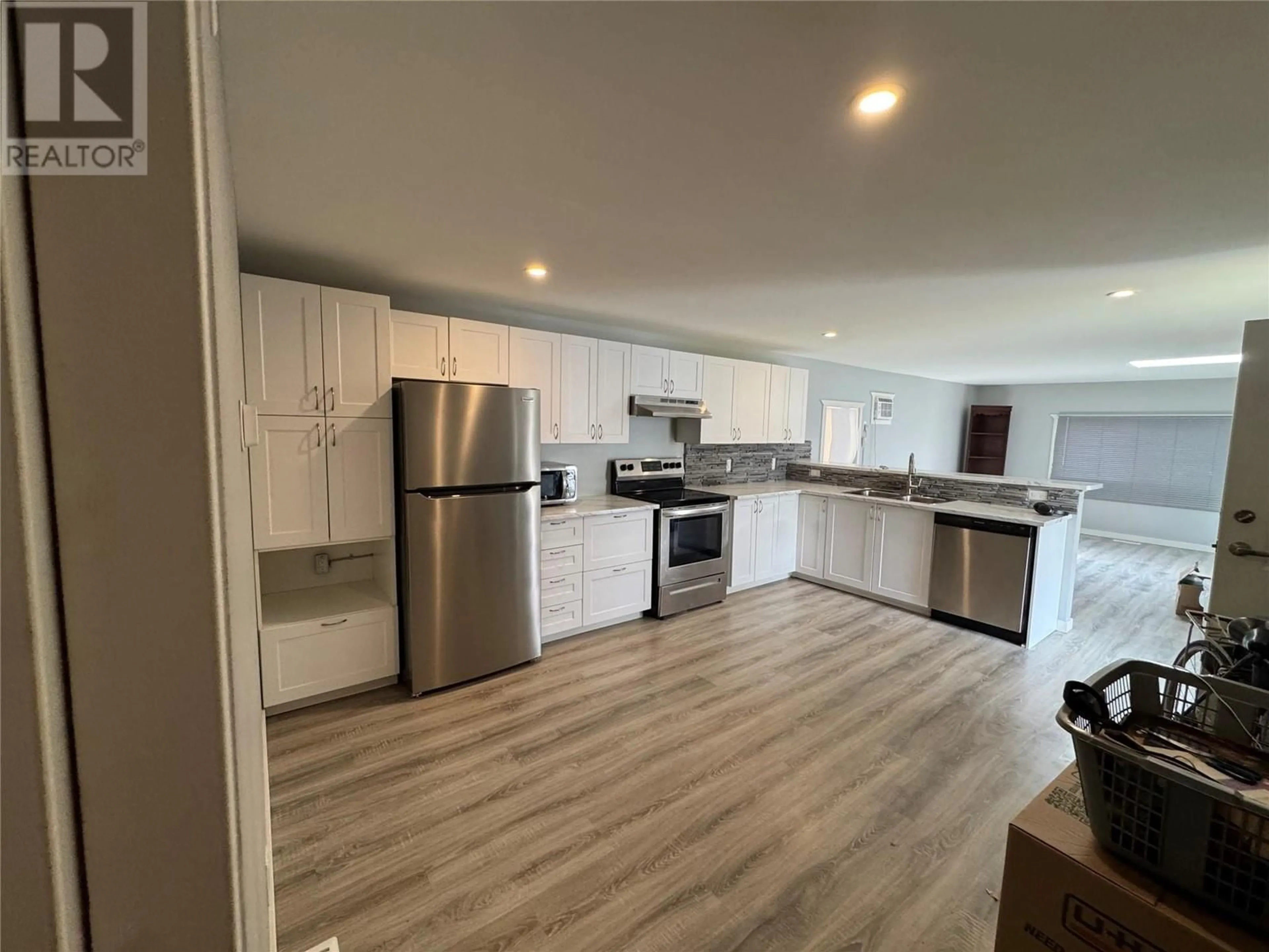 Open concept kitchen, wood/laminate floor for 8 EDWARDS ROAD, Kamloops British Columbia V2B4G1