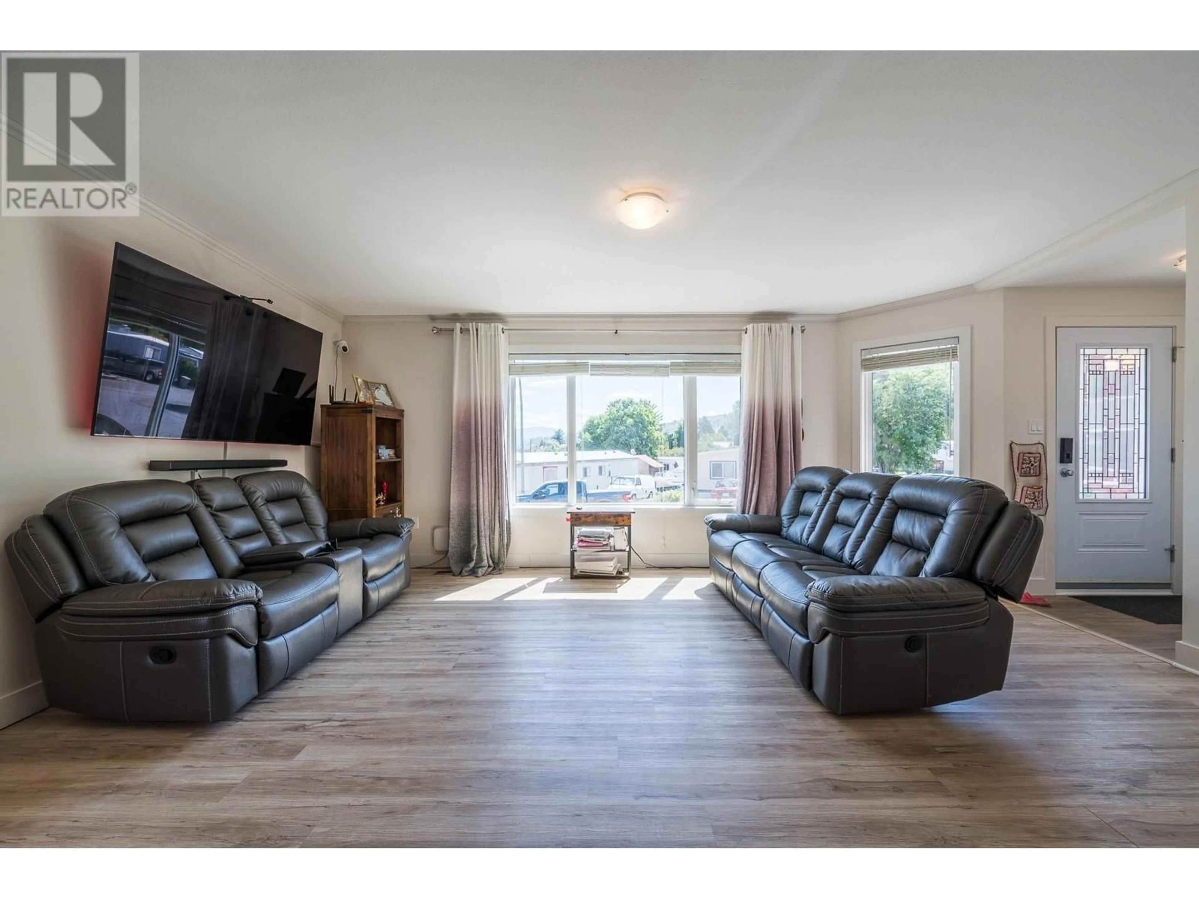 Living room with furniture, wood/laminate floor for B11 - 7155 DALLAS DRIVE, Kamloops British Columbia V2C4T1