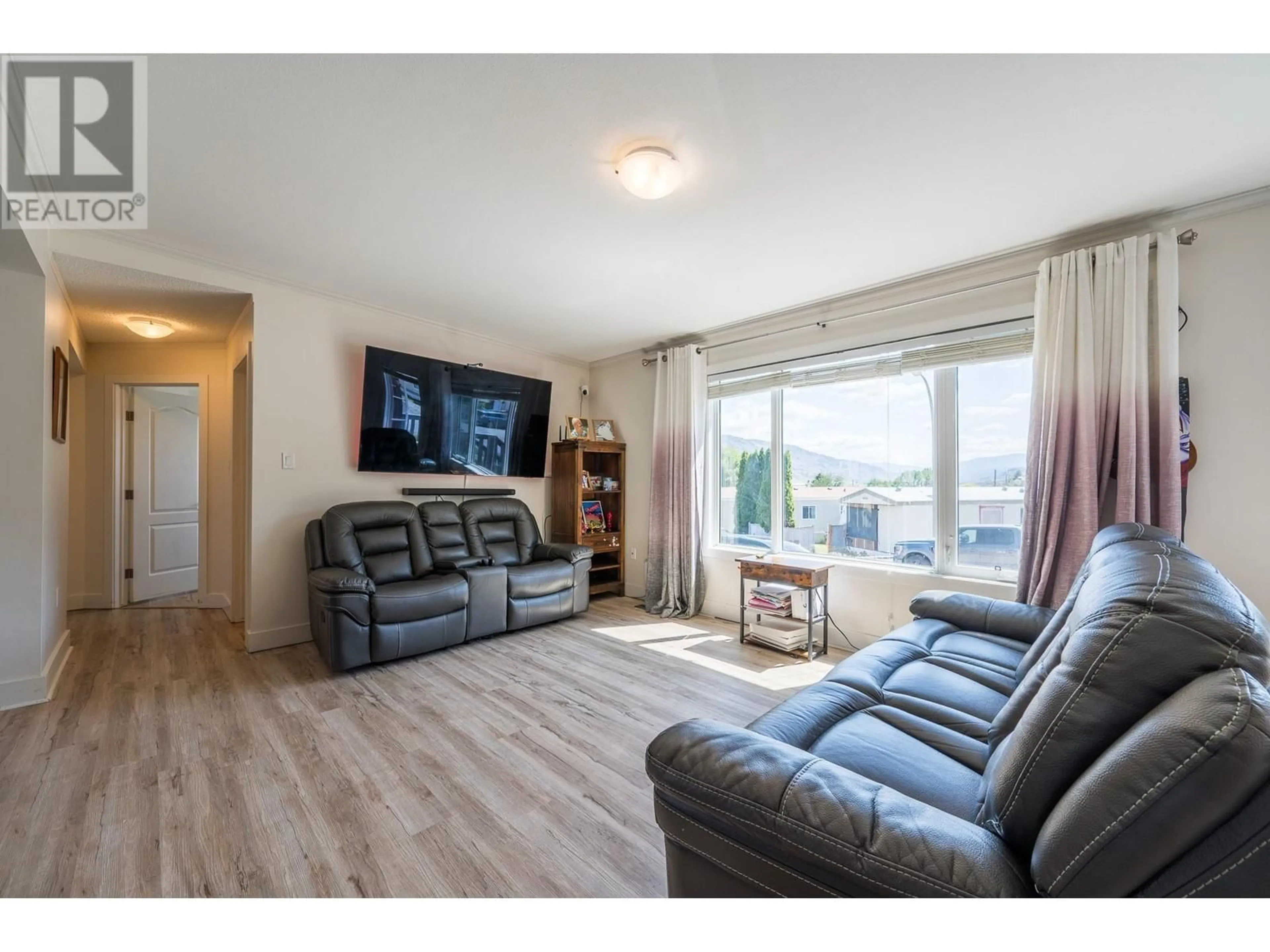 Living room with furniture, wood/laminate floor for B11 - 7155 DALLAS DRIVE, Kamloops British Columbia V2C4T1