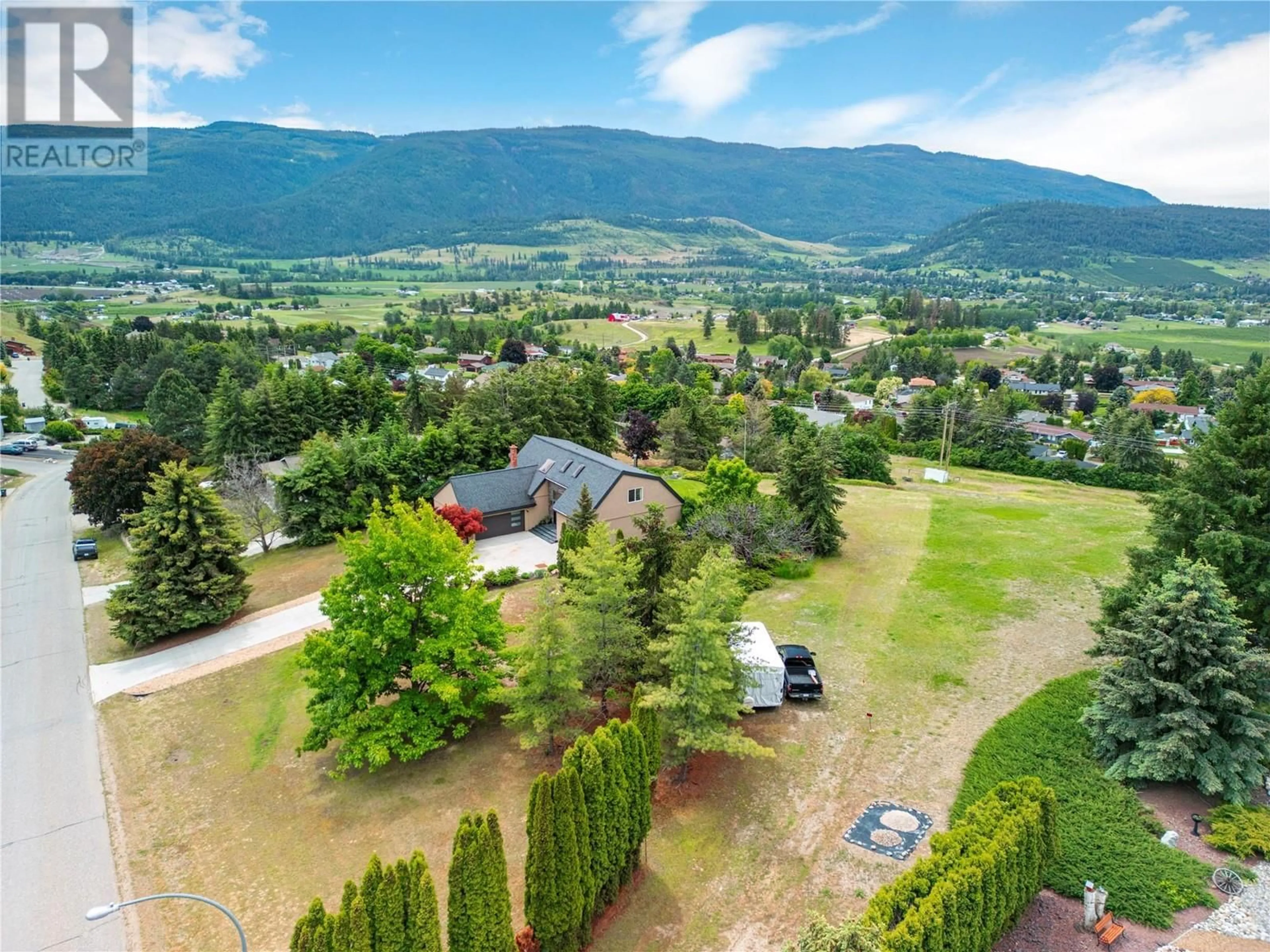 A pic from outside/outdoor area/front of a property/back of a property/a pic from drone, mountain view for 548 UPLAND DRIVE, Coldstream British Columbia V1B2X8
