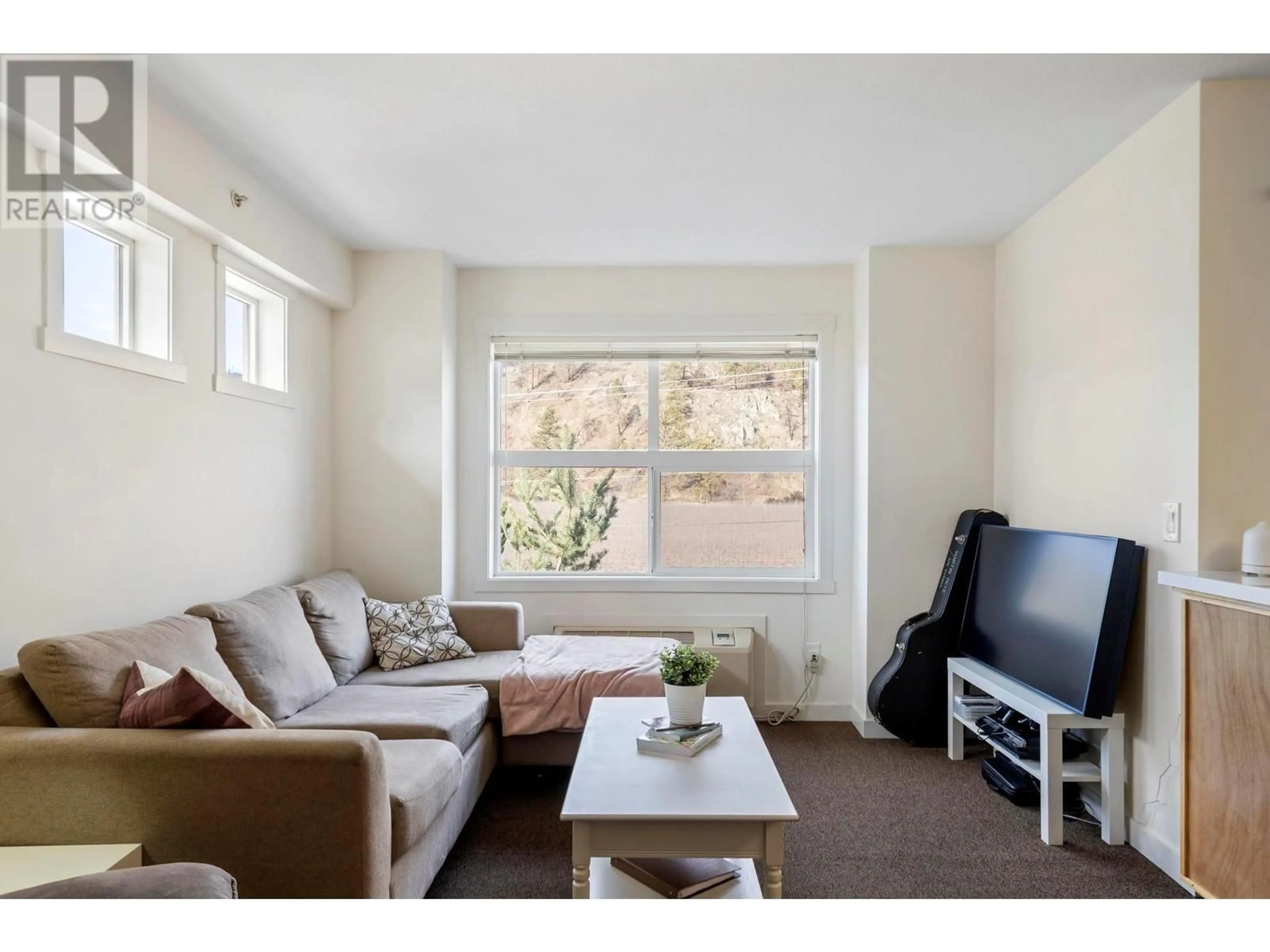 Living room with furniture, wood/laminate floor for 201A - 1475 GLENMORE ROAD NORTH, Kelowna British Columbia V1V2H6