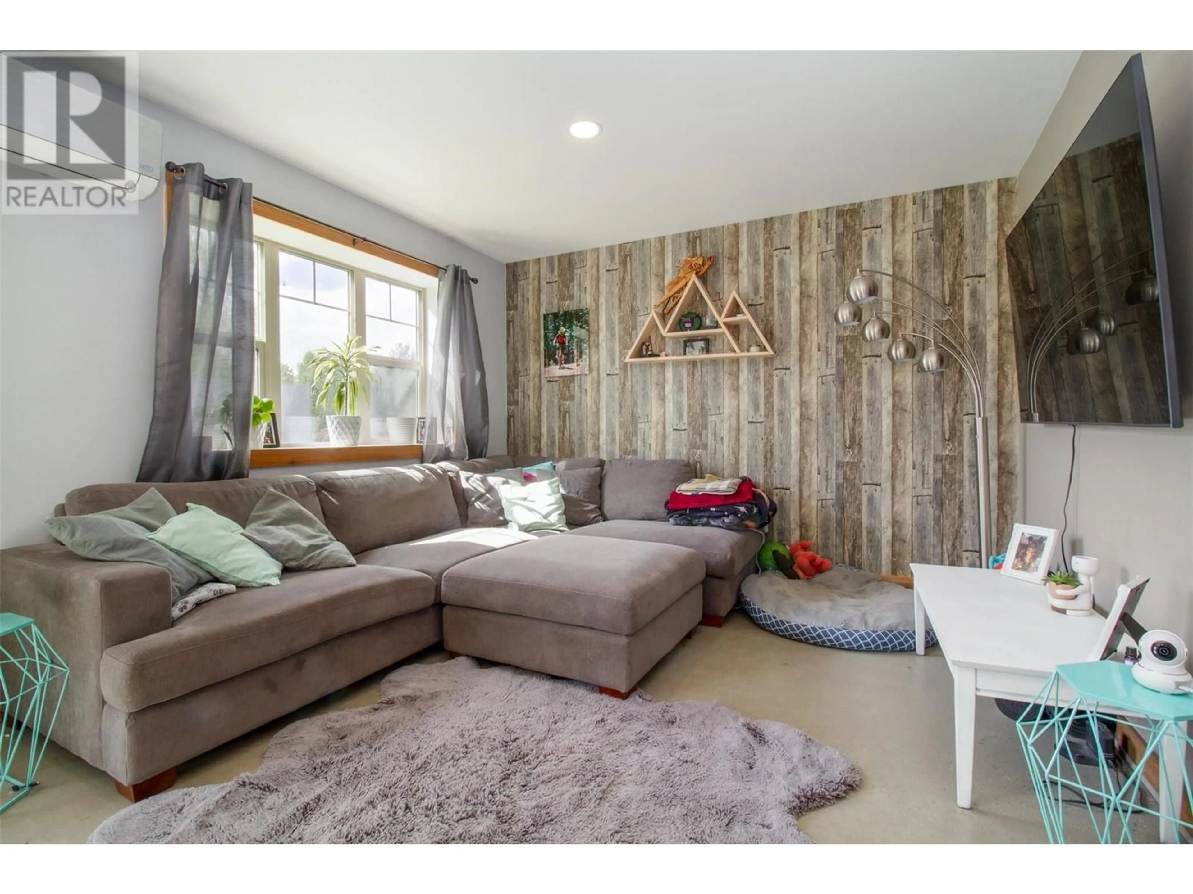Living room with furniture, wood/laminate floor for 1905 HAY ROAD, Revelstoke British Columbia V0E2S1