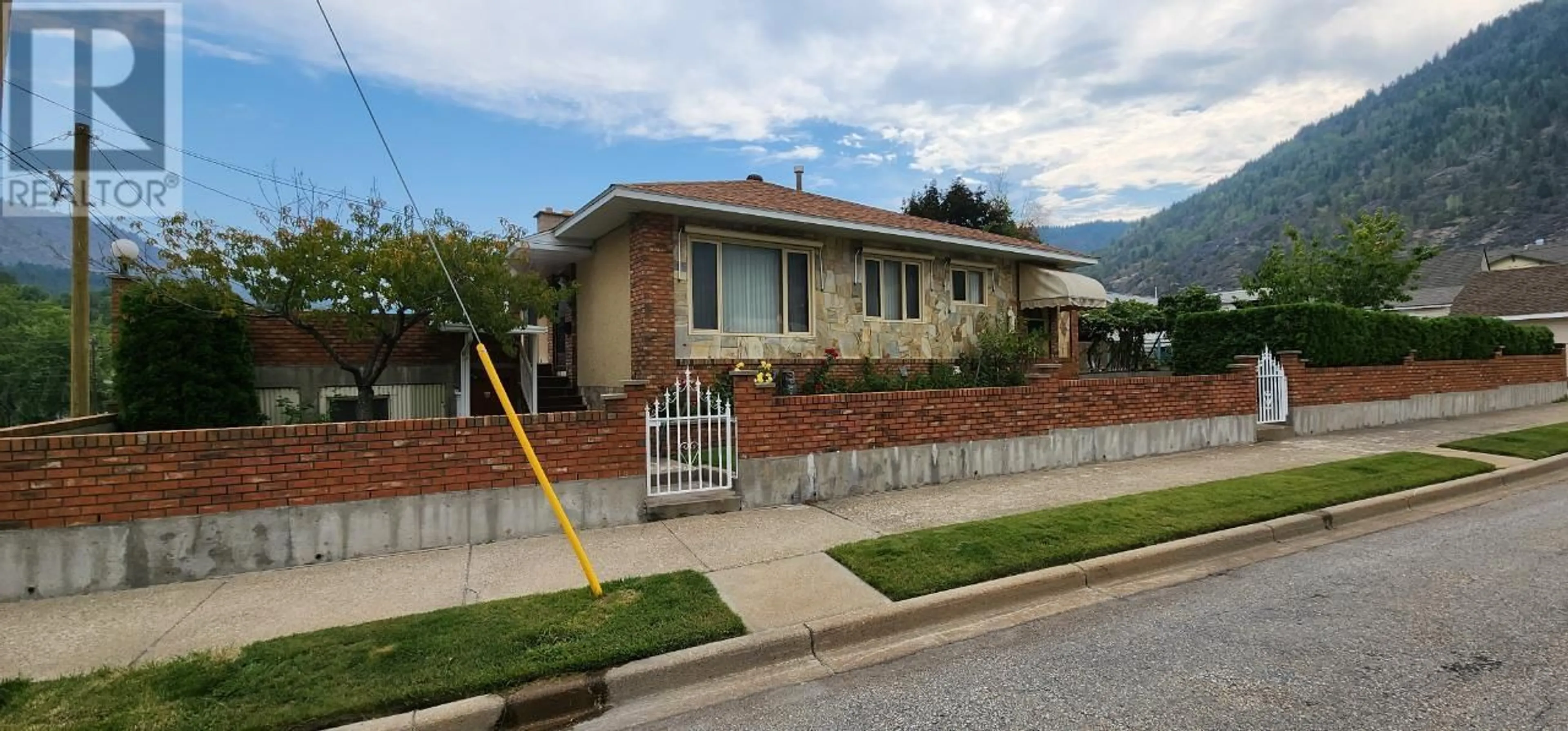 Home with brick exterior material, street for 1912 THIRD AVENUE, Trail British Columbia V1R1R4