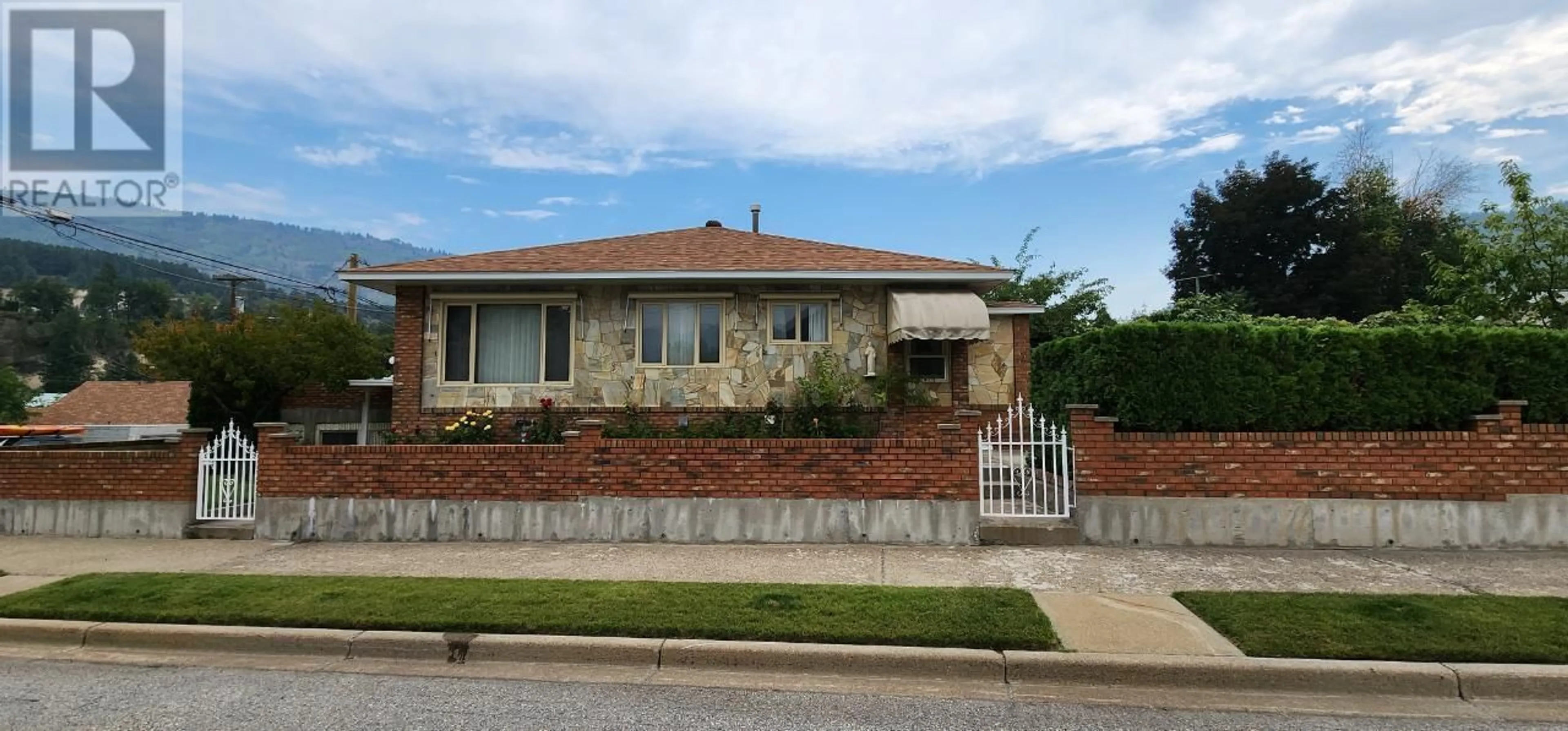 Home with brick exterior material, street for 1912 THIRD AVENUE, Trail British Columbia V1R1R4
