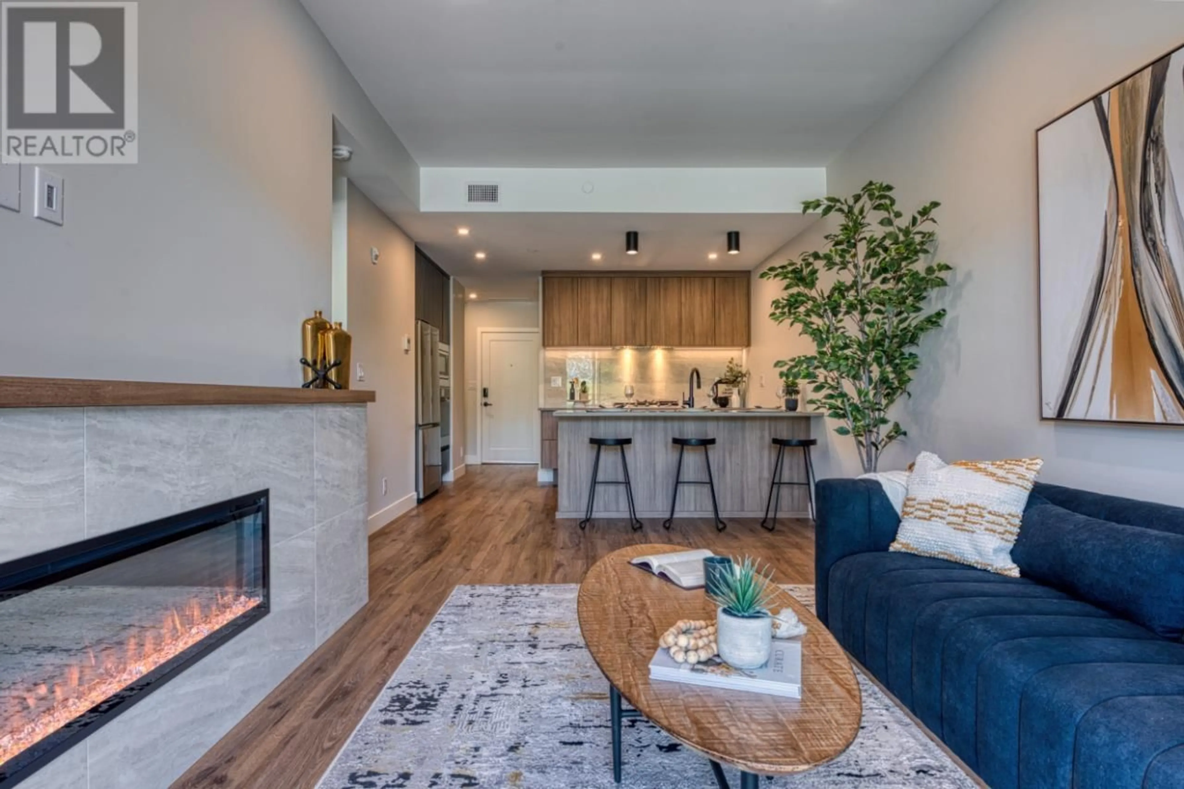 Living room with furniture, wood/laminate floor for 107 - 75 PREDATOR RIDGE DRIVE, Vernon British Columbia V1H0A5
