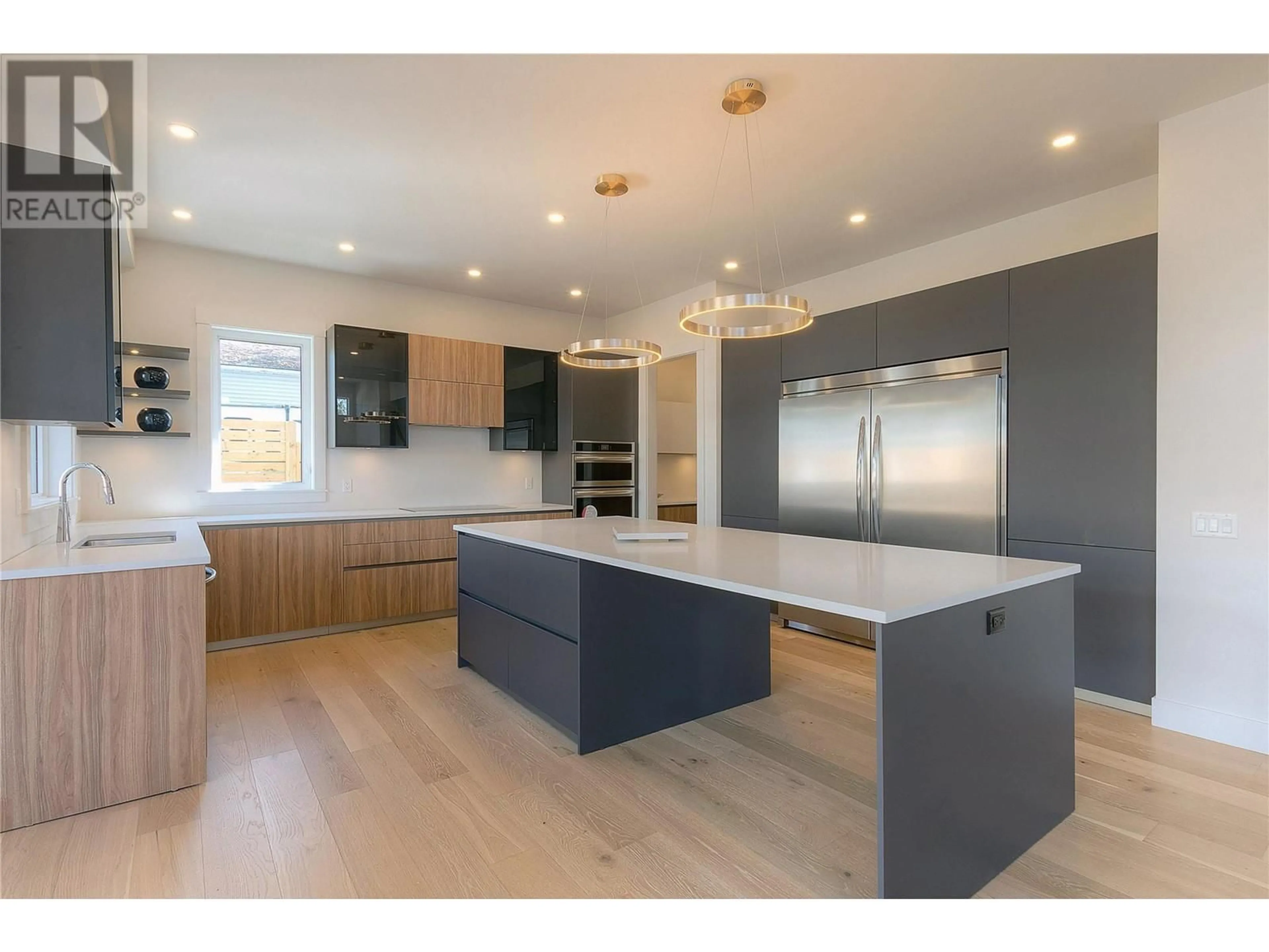 Open concept kitchen, wood/laminate floor for 4621 FORDHAM ROAD, Kelowna British Columbia V1W1P1