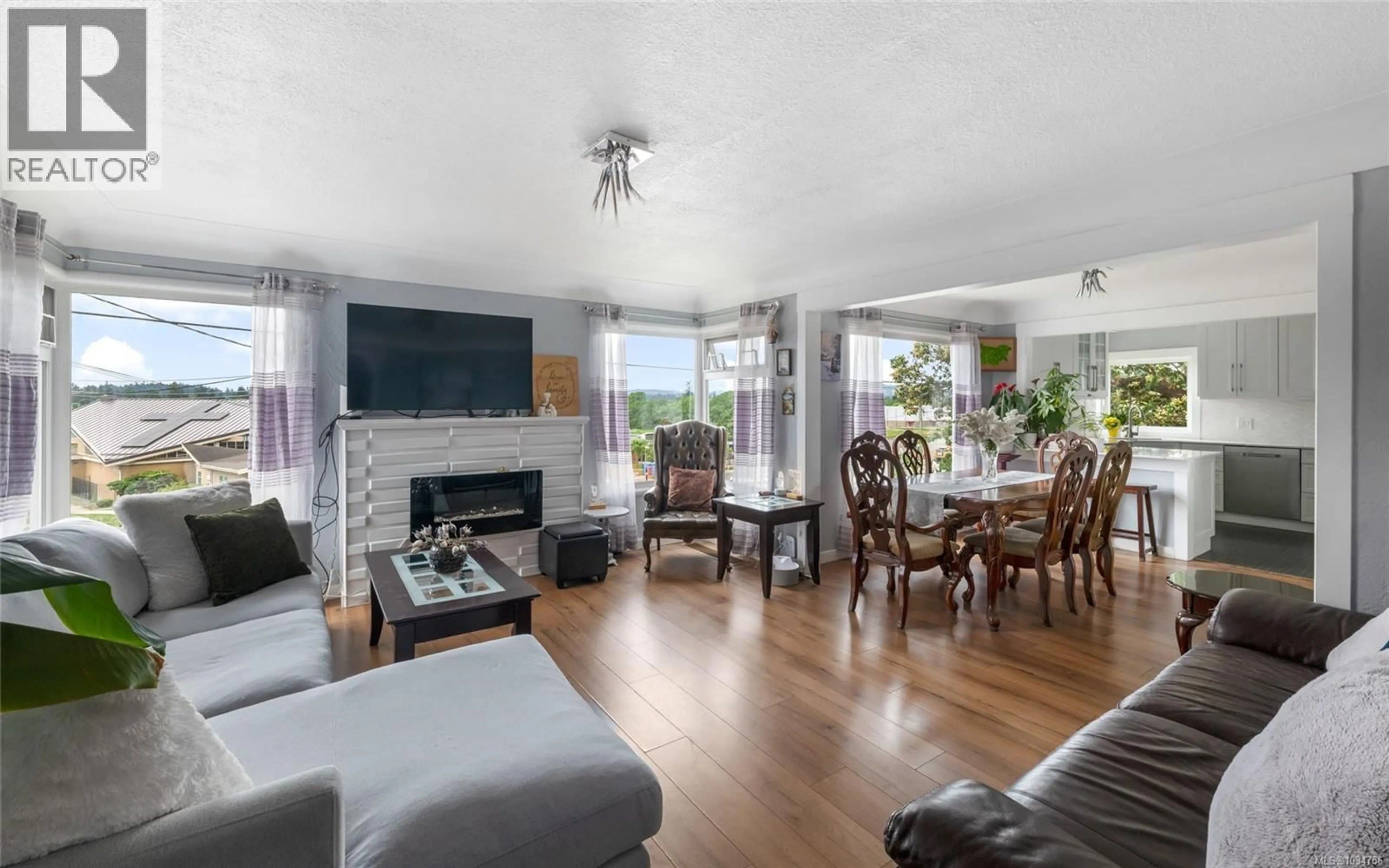 Living room with furniture, wood/laminate floor for 730 BURNSIDE ROAD WEST, Saanich British Columbia V8Z1N1