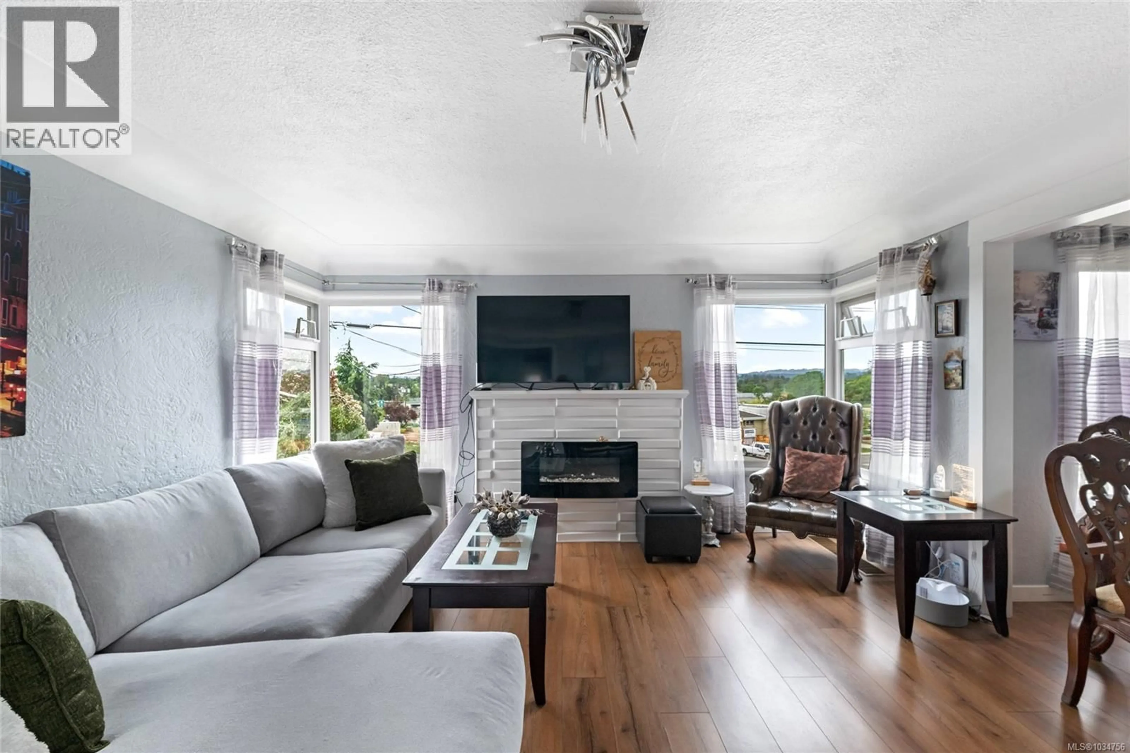 Living room with furniture, wood/laminate floor for 730 BURNSIDE ROAD WEST, Saanich British Columbia V8Z1N1