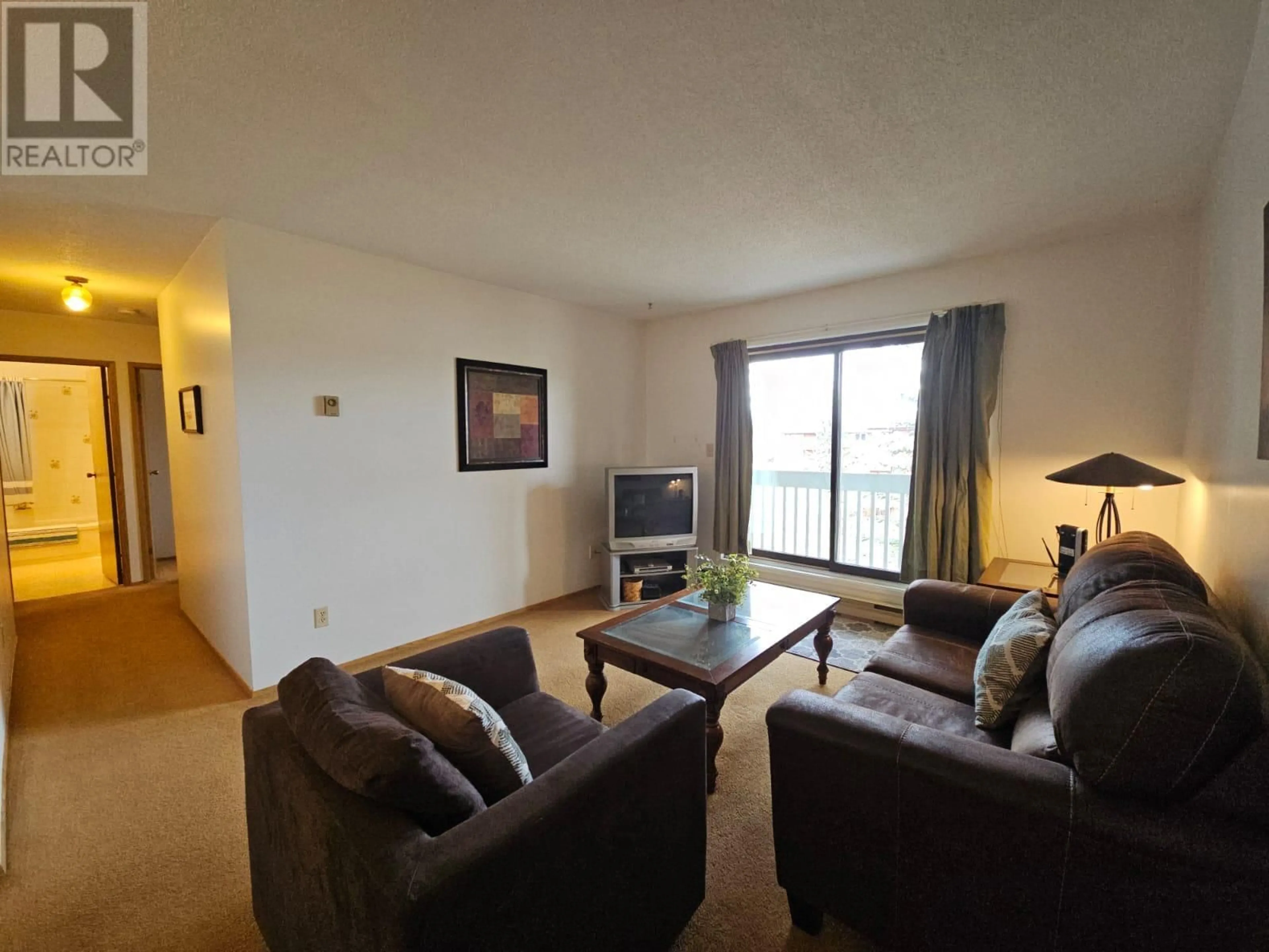 Living room with furniture, wood/laminate floor for 310 - 320 NORTHGATE OTHER, Tumbler Ridge British Columbia V0C2W0