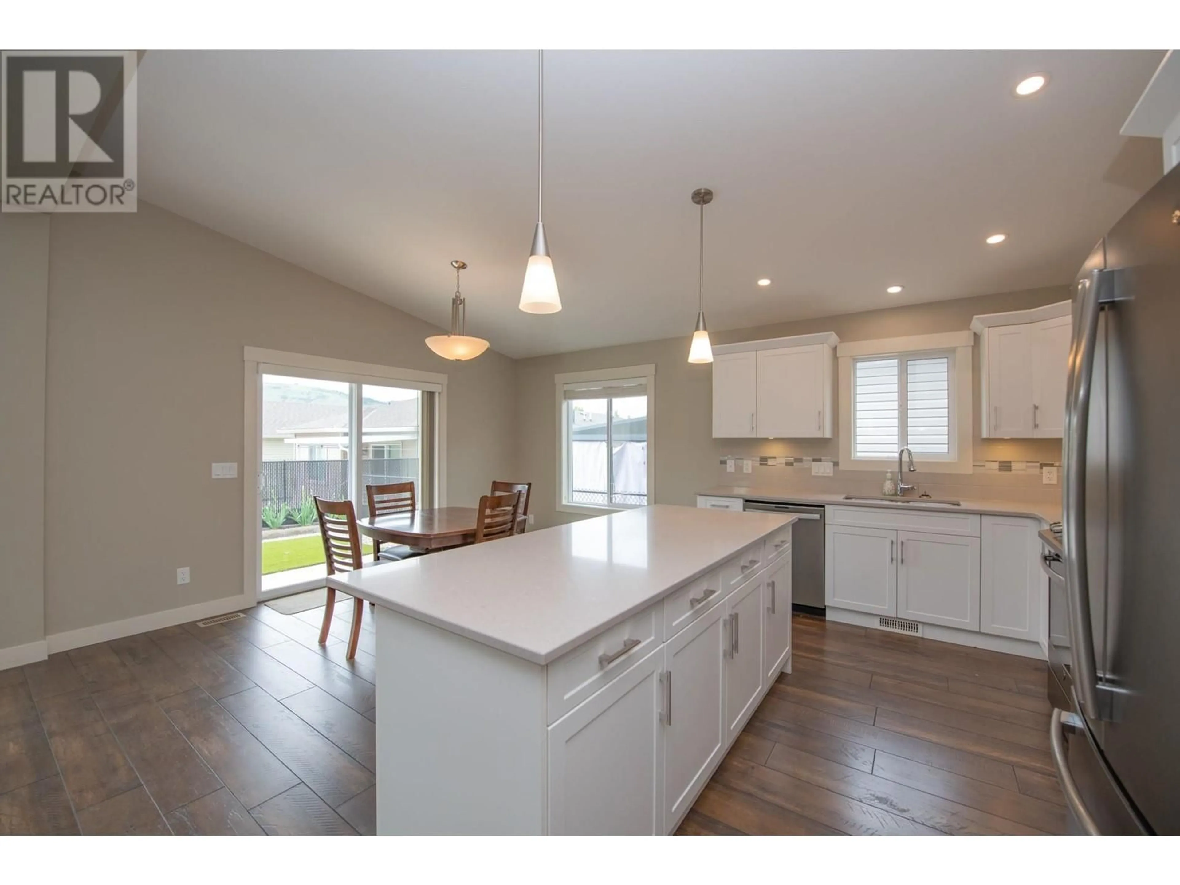 Open concept kitchen, wood/laminate floor for 71 - 2100 55 AVENUE, Vernon British Columbia V1T9Y6