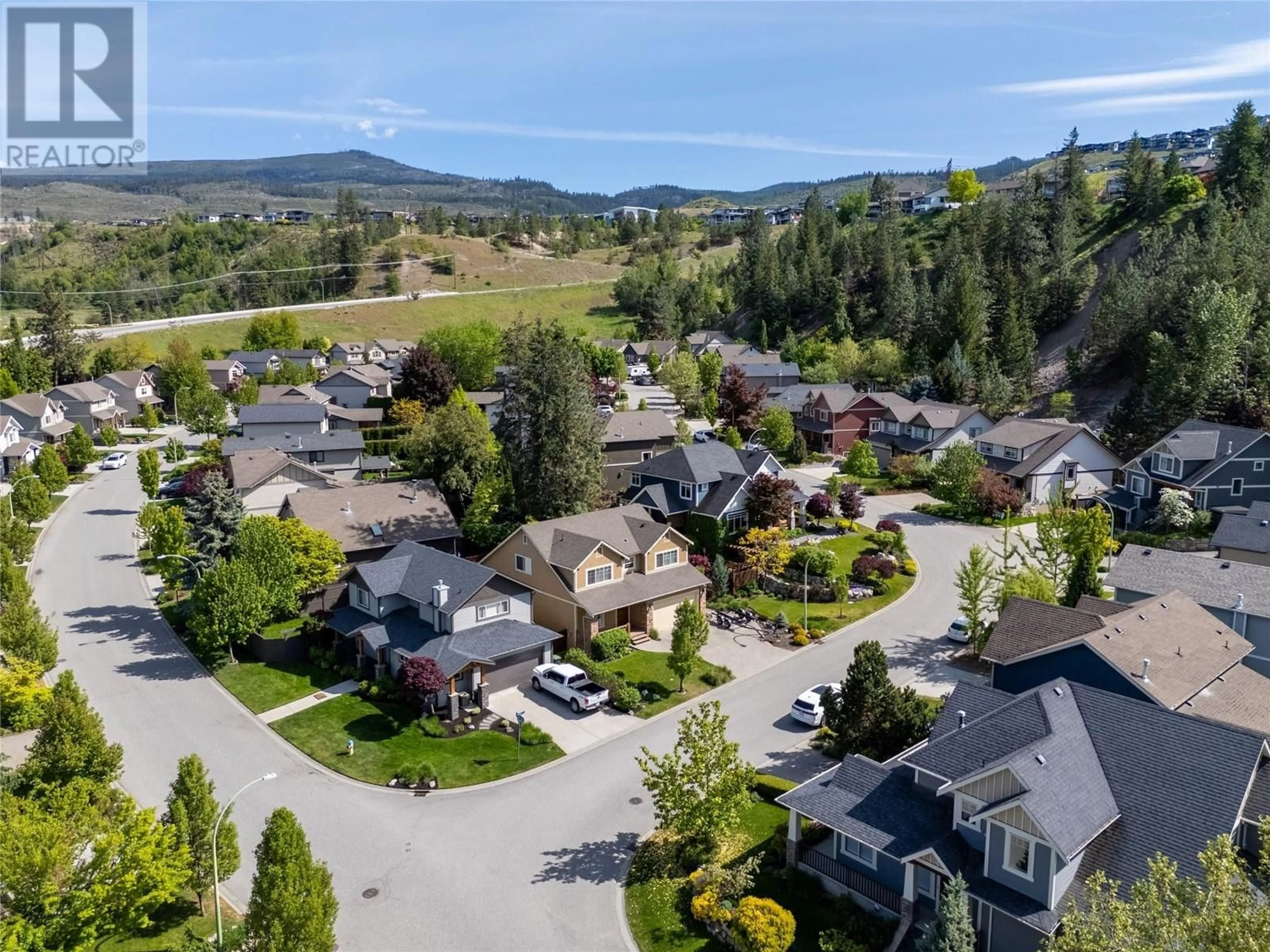 A pic from outside/outdoor area/front of a property/back of a property/a pic from drone, mountain view for 1116 PARET CRESCENT, Kelowna British Columbia V1W4X8