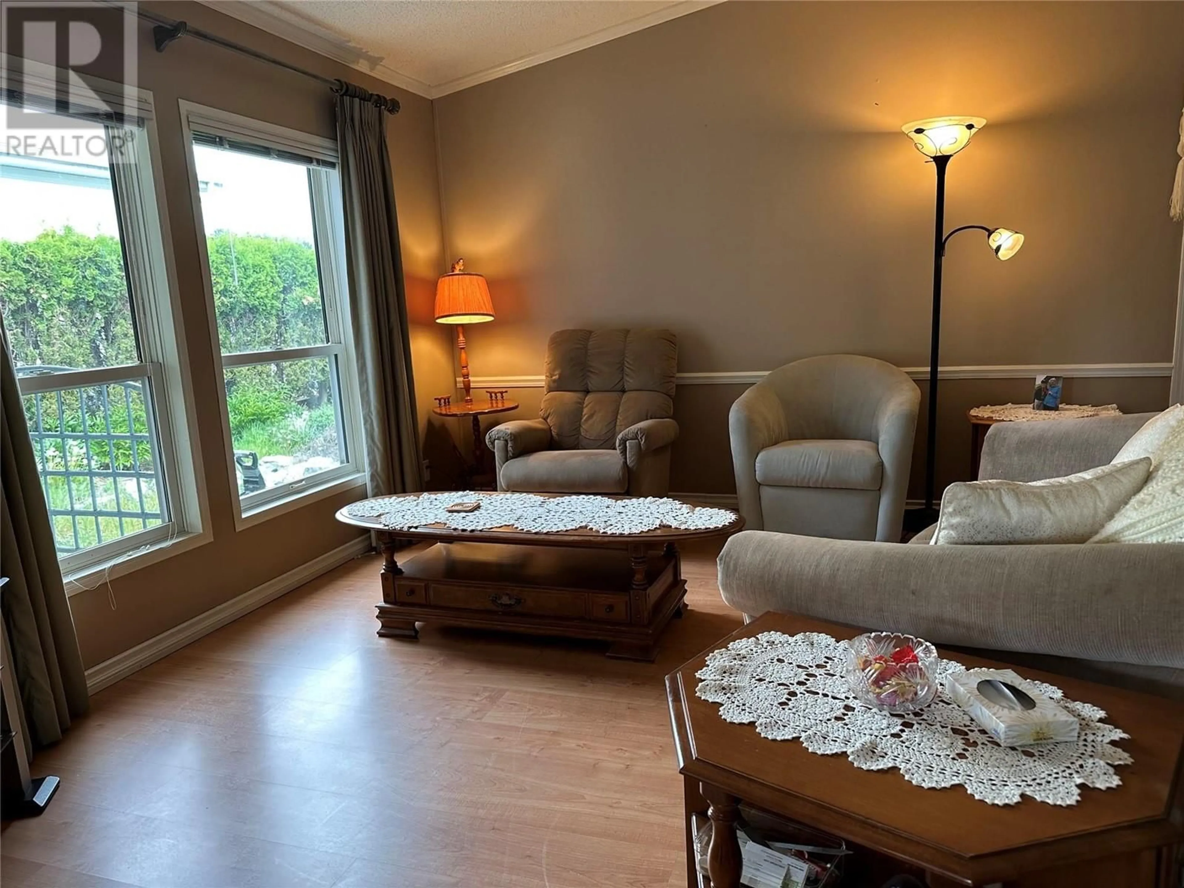 Living room with furniture, wood/laminate floor for A6 - 5484 25 AVENUE, Vernon British Columbia V1T7A8