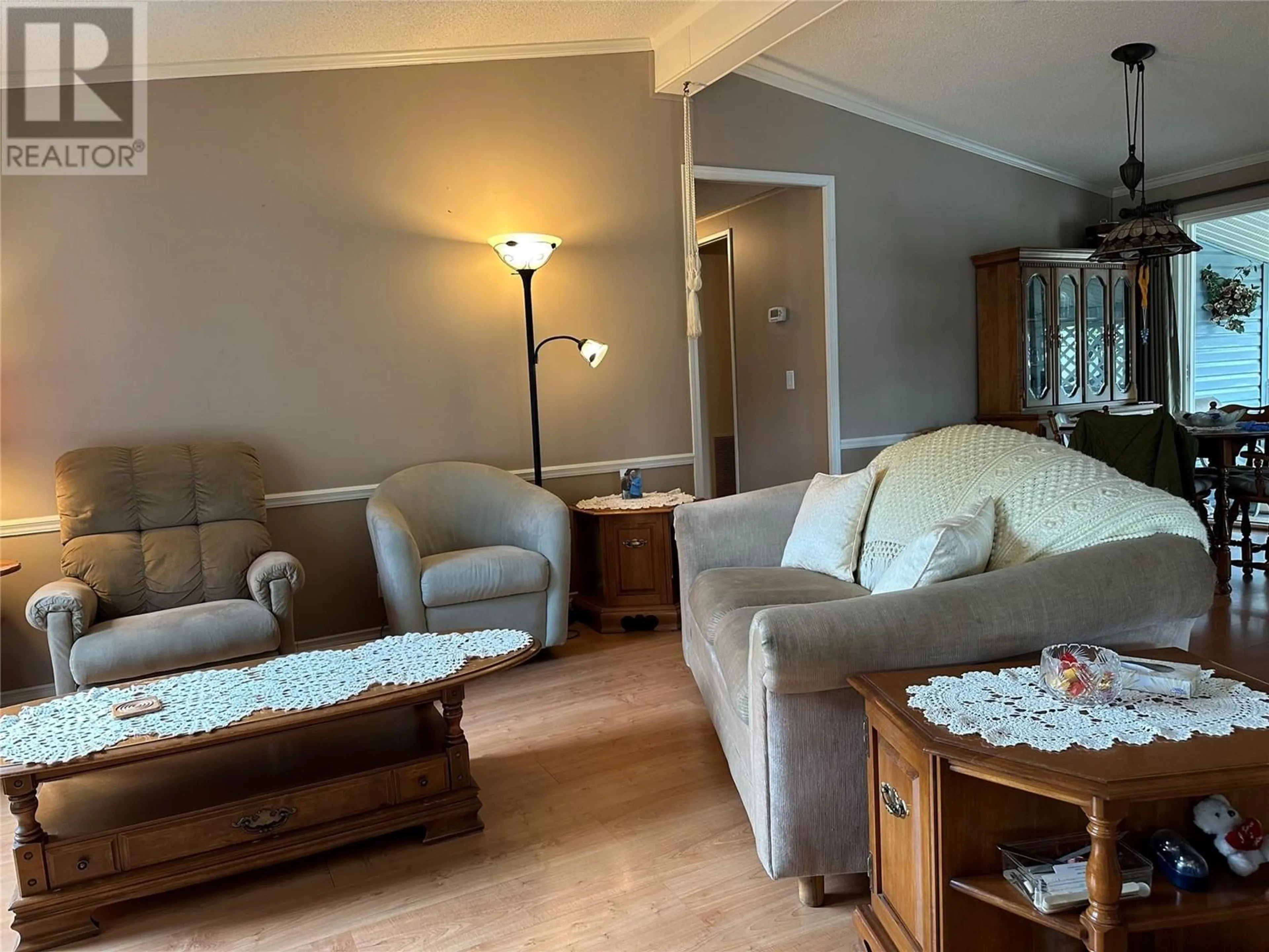 Living room with furniture, wood/laminate floor for A6 - 5484 25 AVENUE, Vernon British Columbia V1T7A8