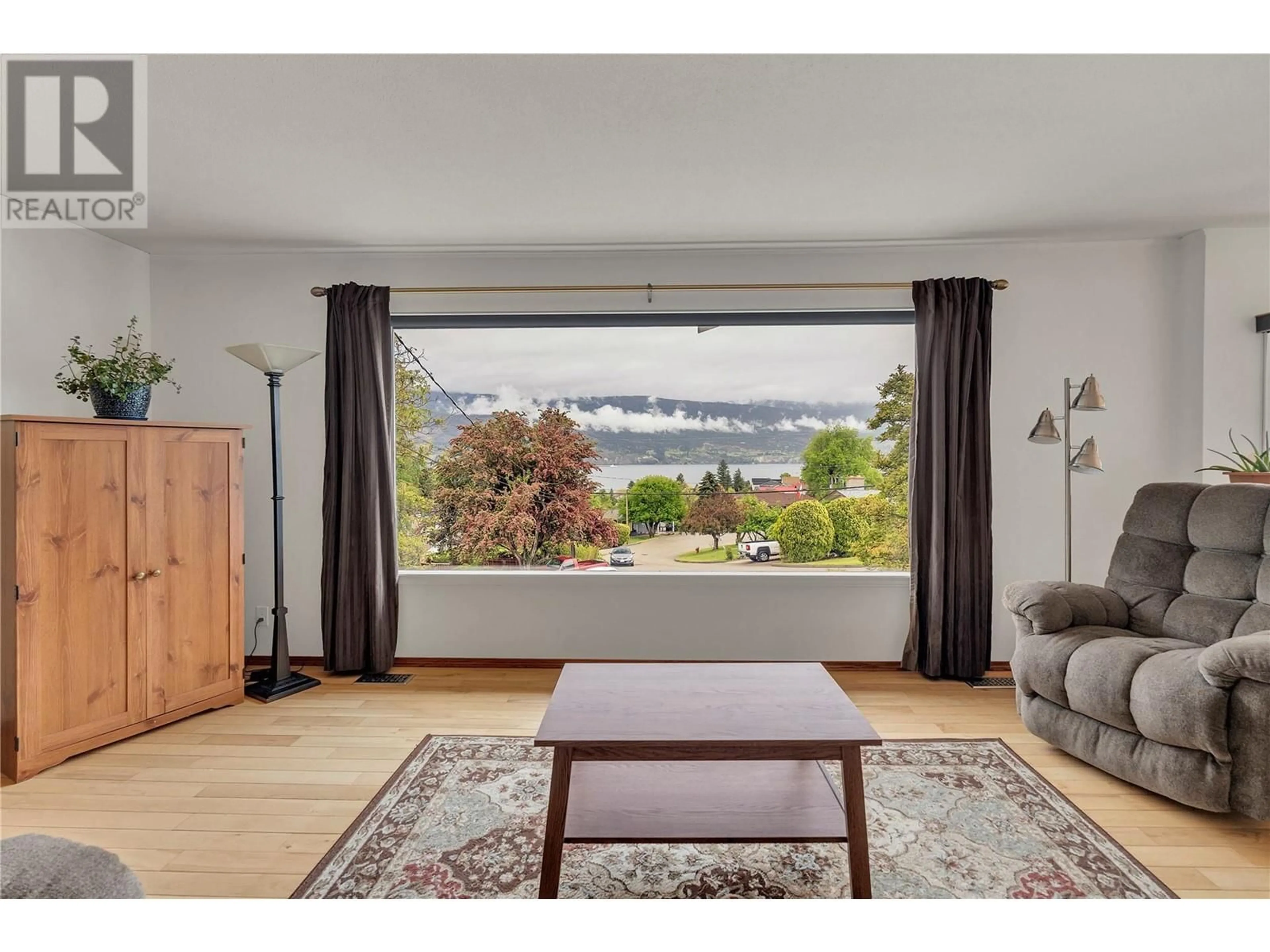 Living room with furniture, wood/laminate floor for 6528 LIPSETT CRESCENT, Summerland British Columbia V0H1Z1