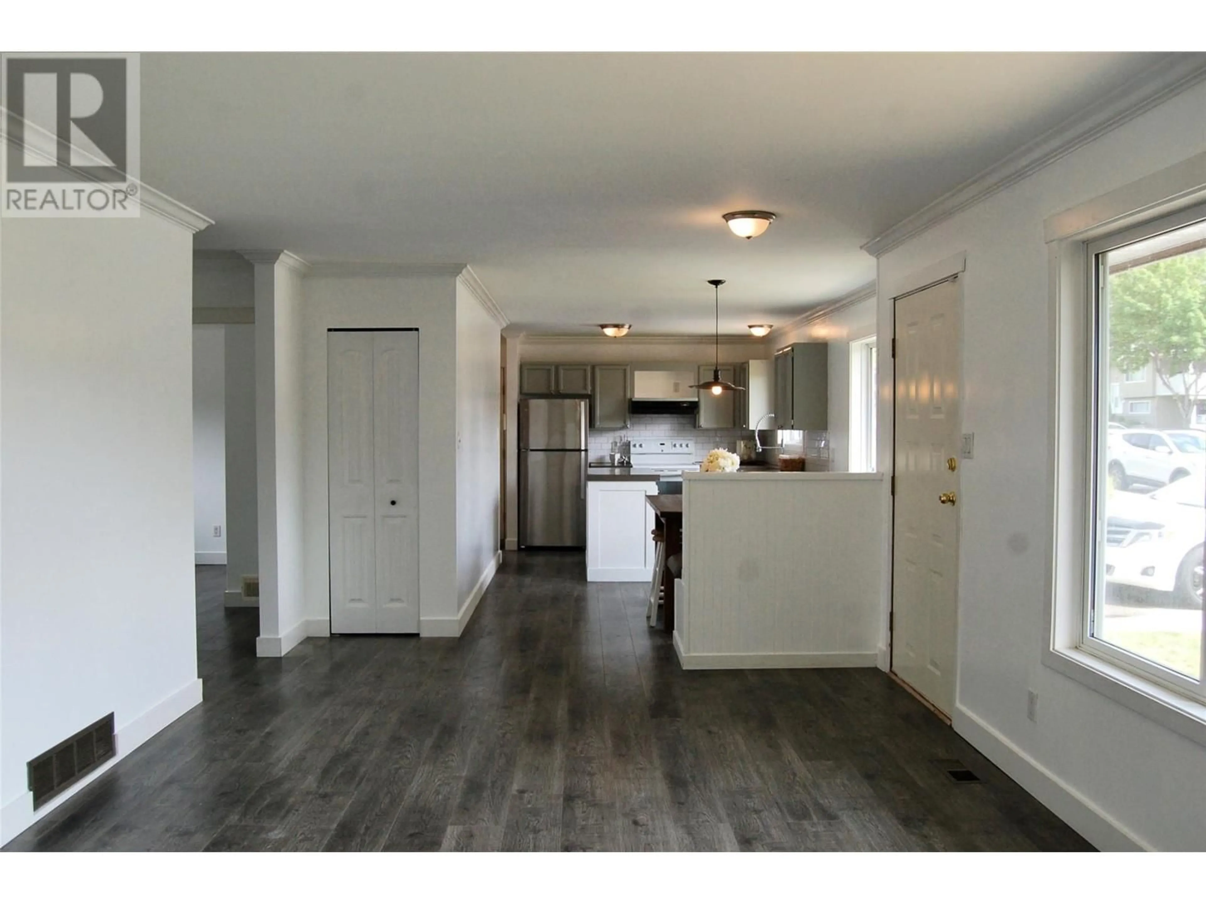 Open concept kitchen, wood/laminate floor for 103 CLELAND DRIVE, Penticton British Columbia V2A7H4