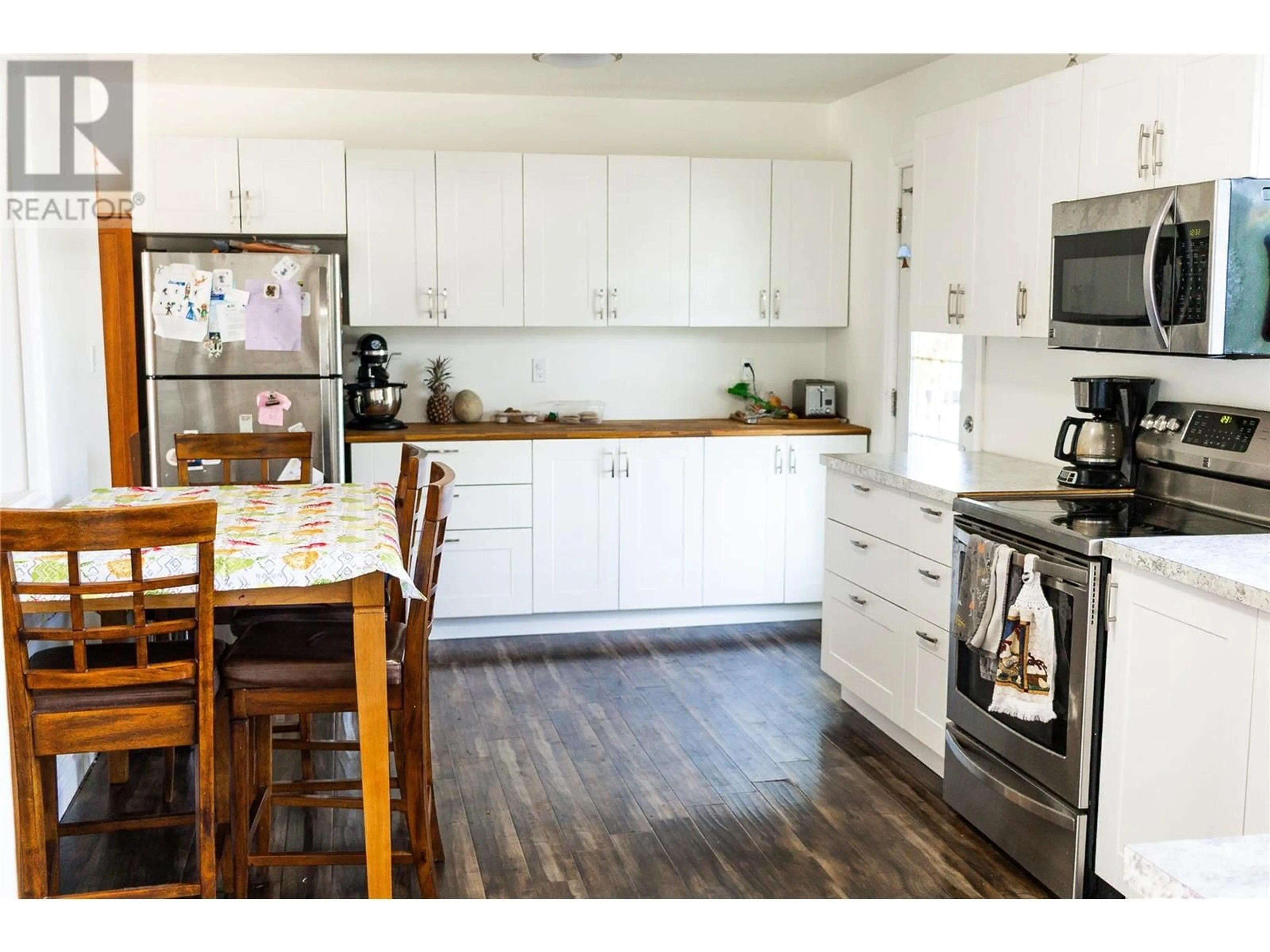 Open concept kitchen, wood/laminate floor for 1924 90 AVENUE, Dawson Creek British Columbia V1G1A6
