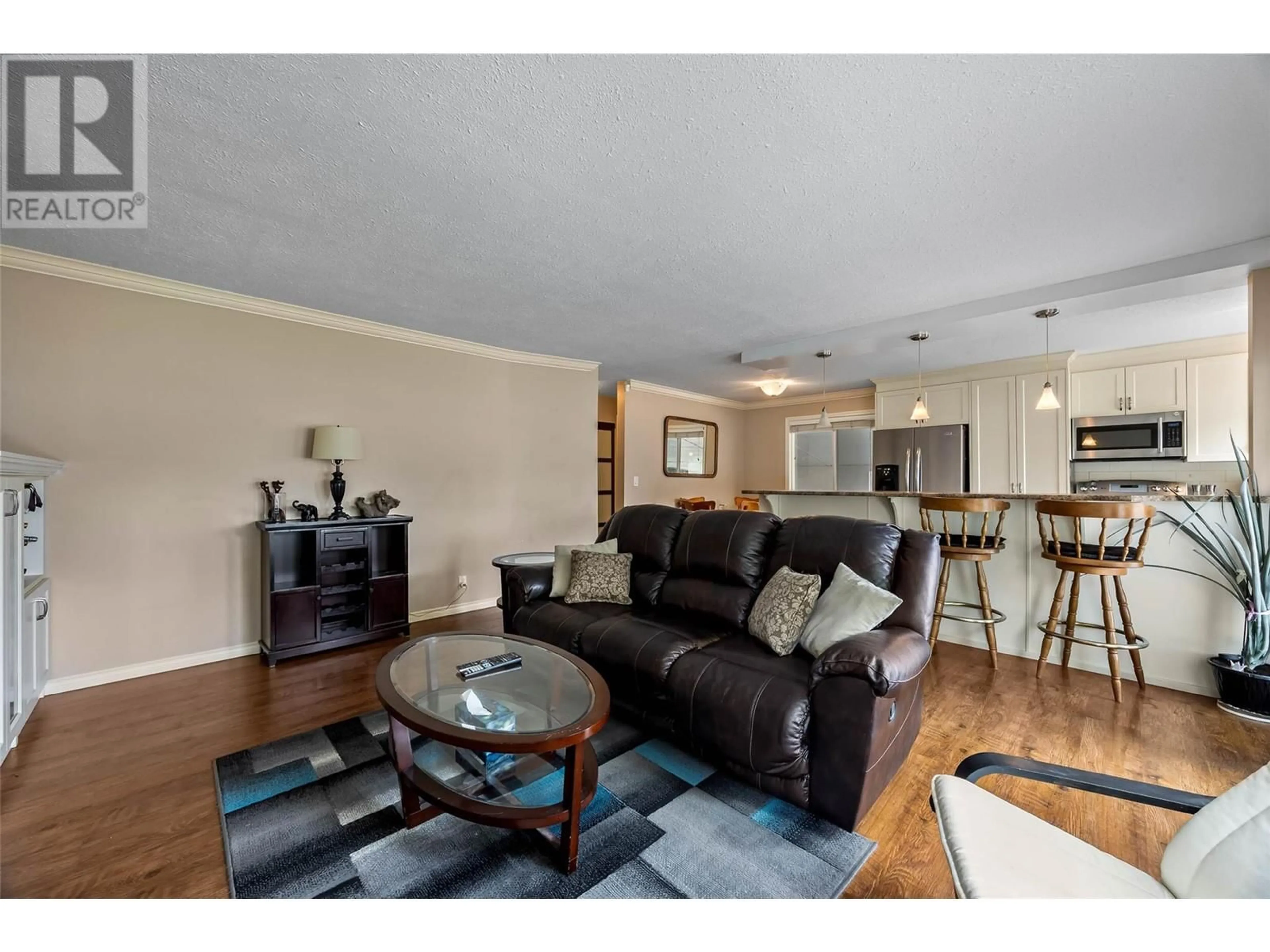 Living room with furniture, wood/laminate floor for 840 AGASSIZ ROAD, Kamloops British Columbia V2B6G8