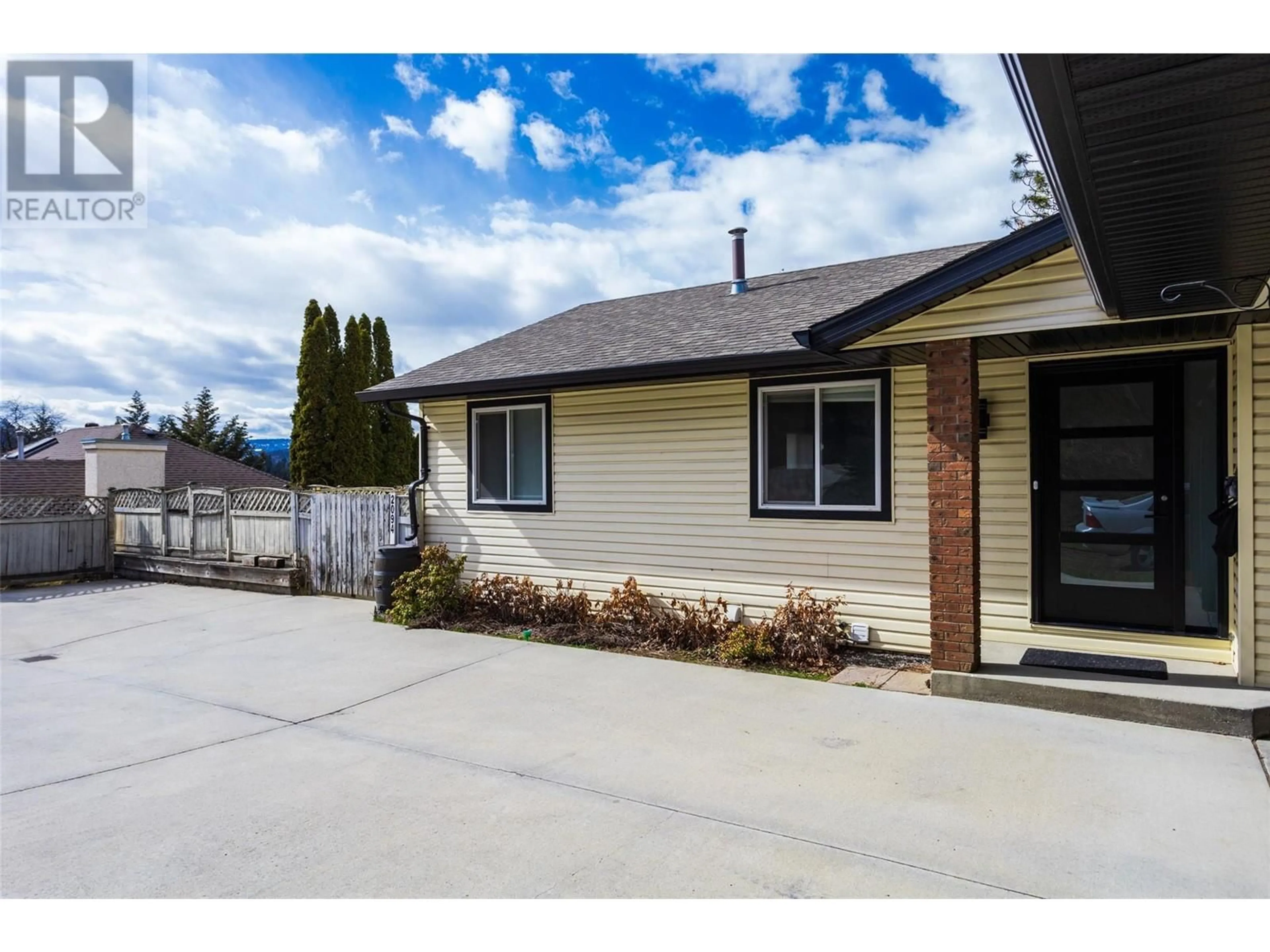 Home with vinyl exterior material, street for 2094 TOMAT AVENUE, Kelowna British Columbia V1Z3J2