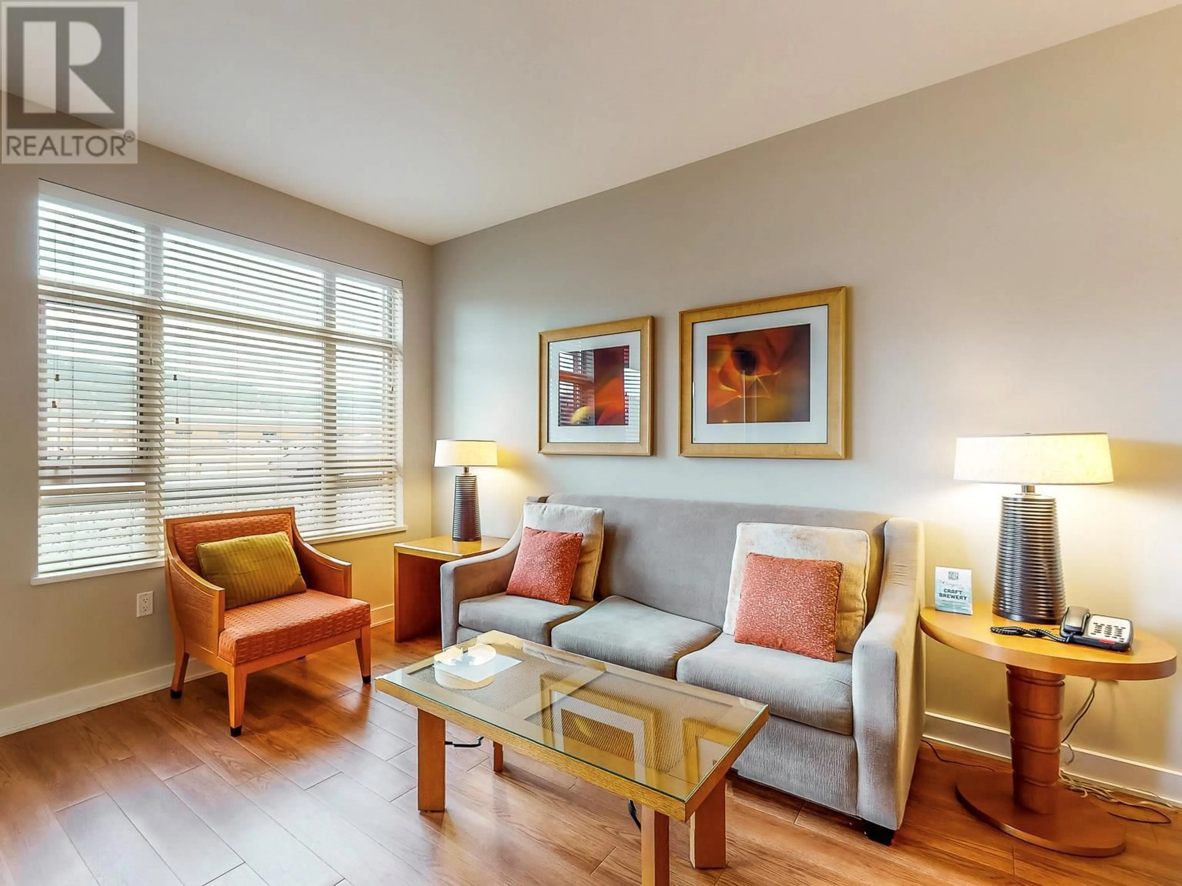 Living room with furniture, wood/laminate floor for 413 - 15 PARK PLACE, Osoyoos British Columbia V0H1V0