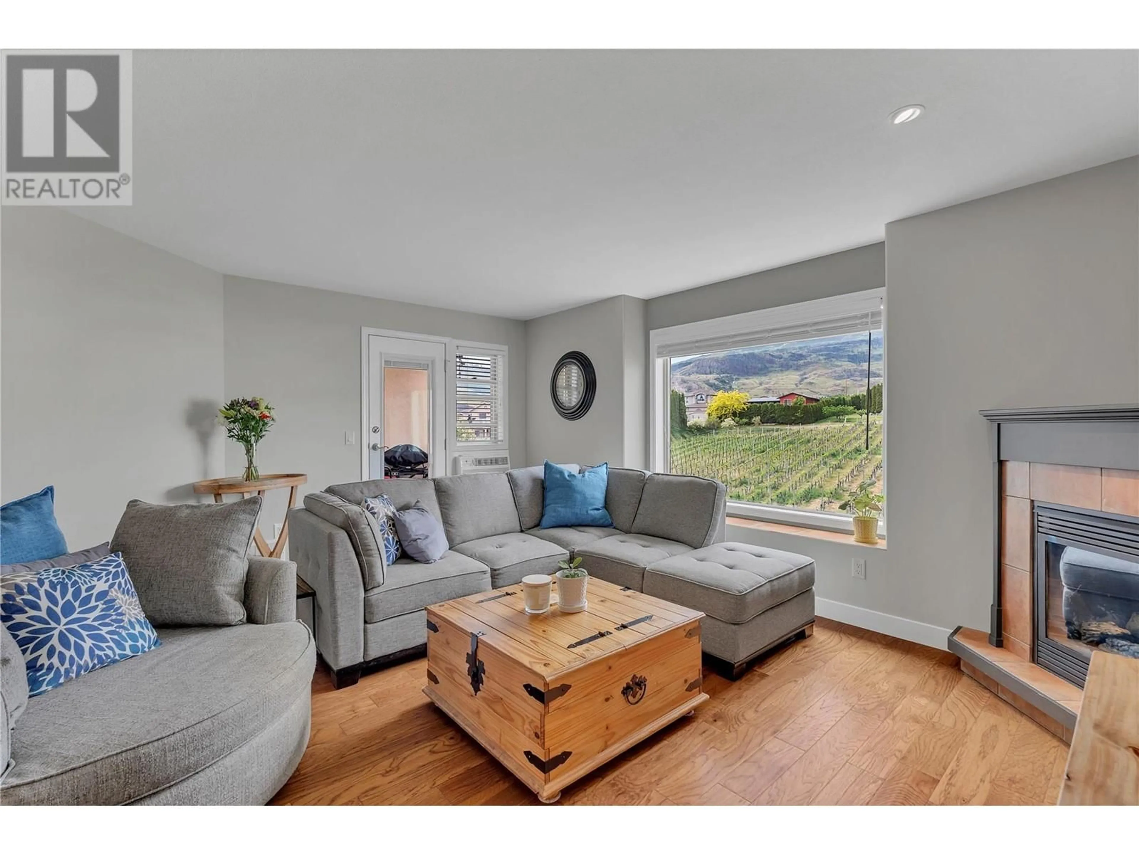 Living room with furniture, wood/laminate floor for 309 - 9307 62 AVENUE, Osoyoos British Columbia V0H1V4