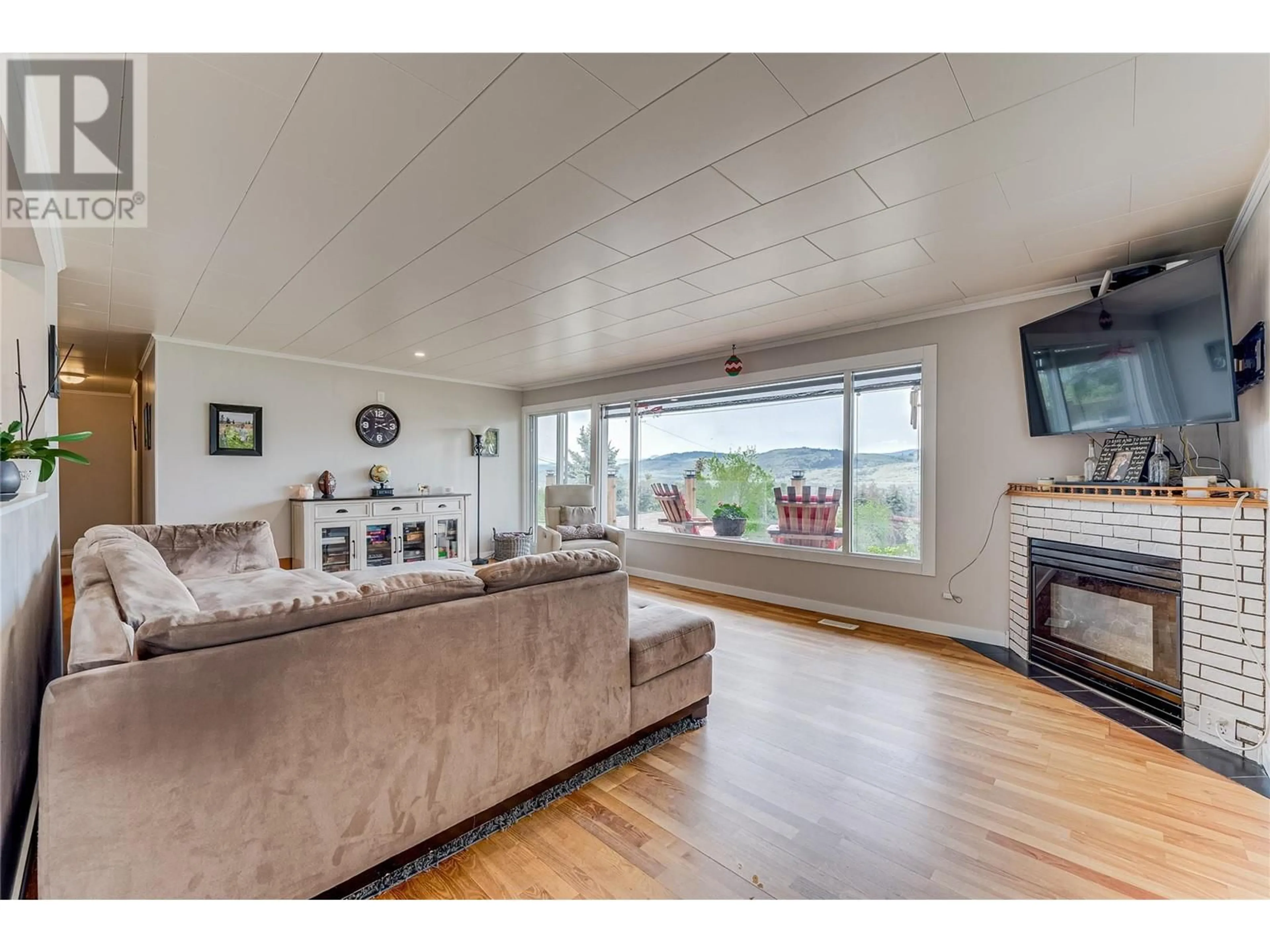 Living room with furniture, wood/laminate floor for 7268 L & A ROAD, Vernon British Columbia V1B3S8