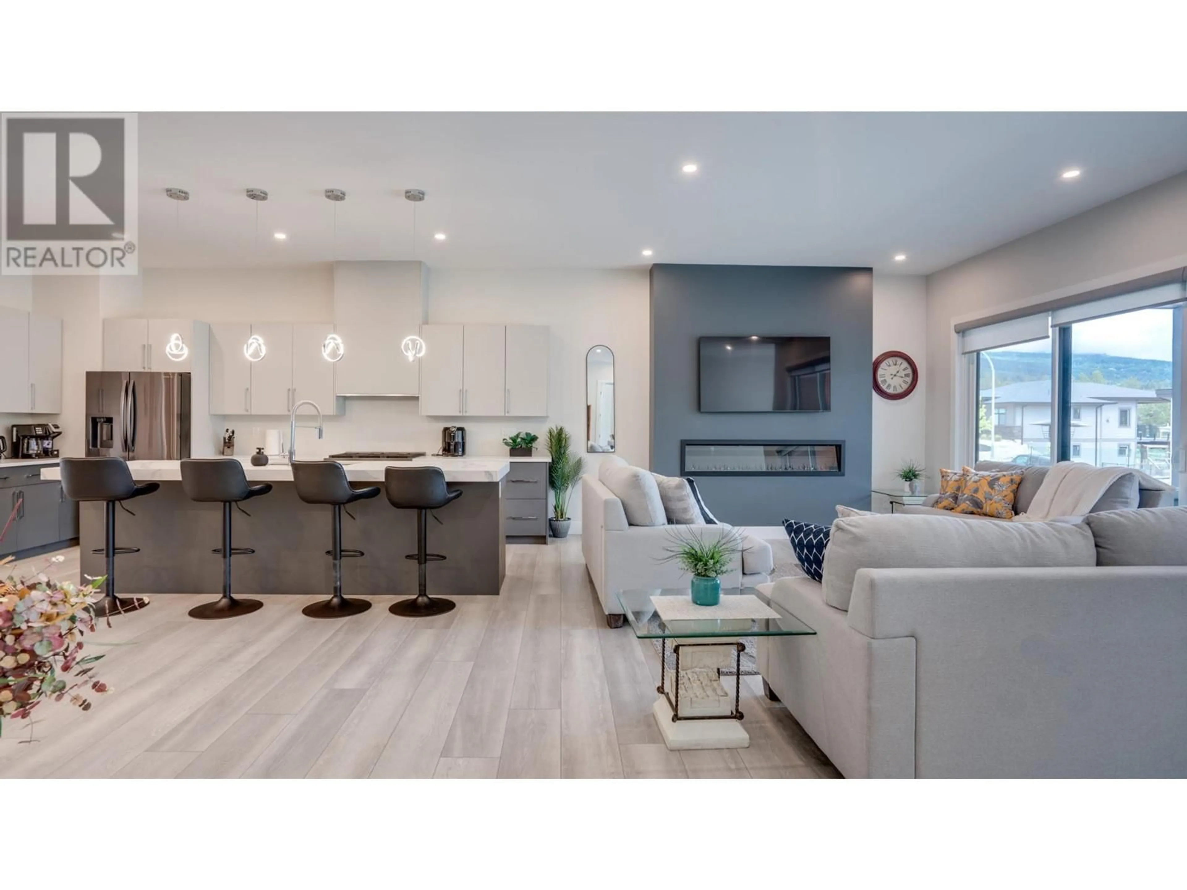 Open concept kitchen, wood/laminate floor for 7141 NAKISKA DRIVE, Vernon British Columbia V1B3M5