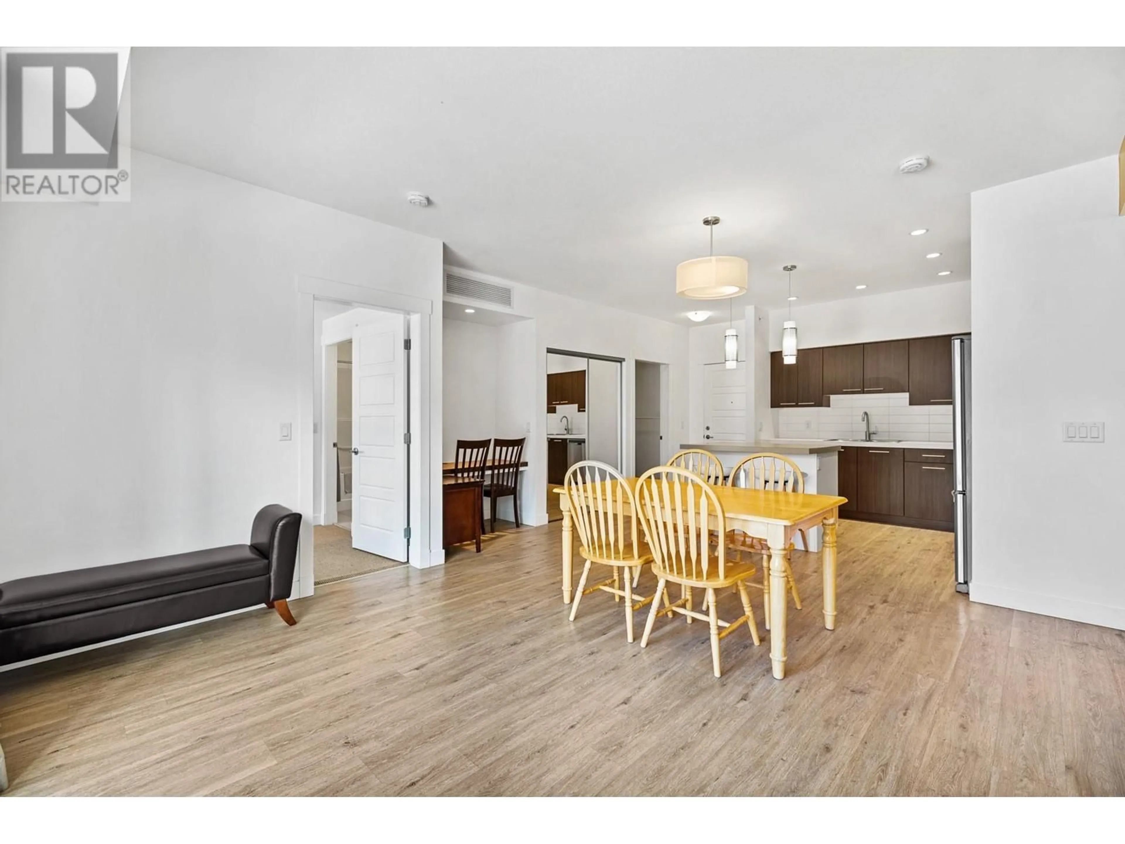 Open concept kitchen, wood/laminate floor for 308 - 985 ACADEMY WAY, Kelowna British Columbia V1V3C8