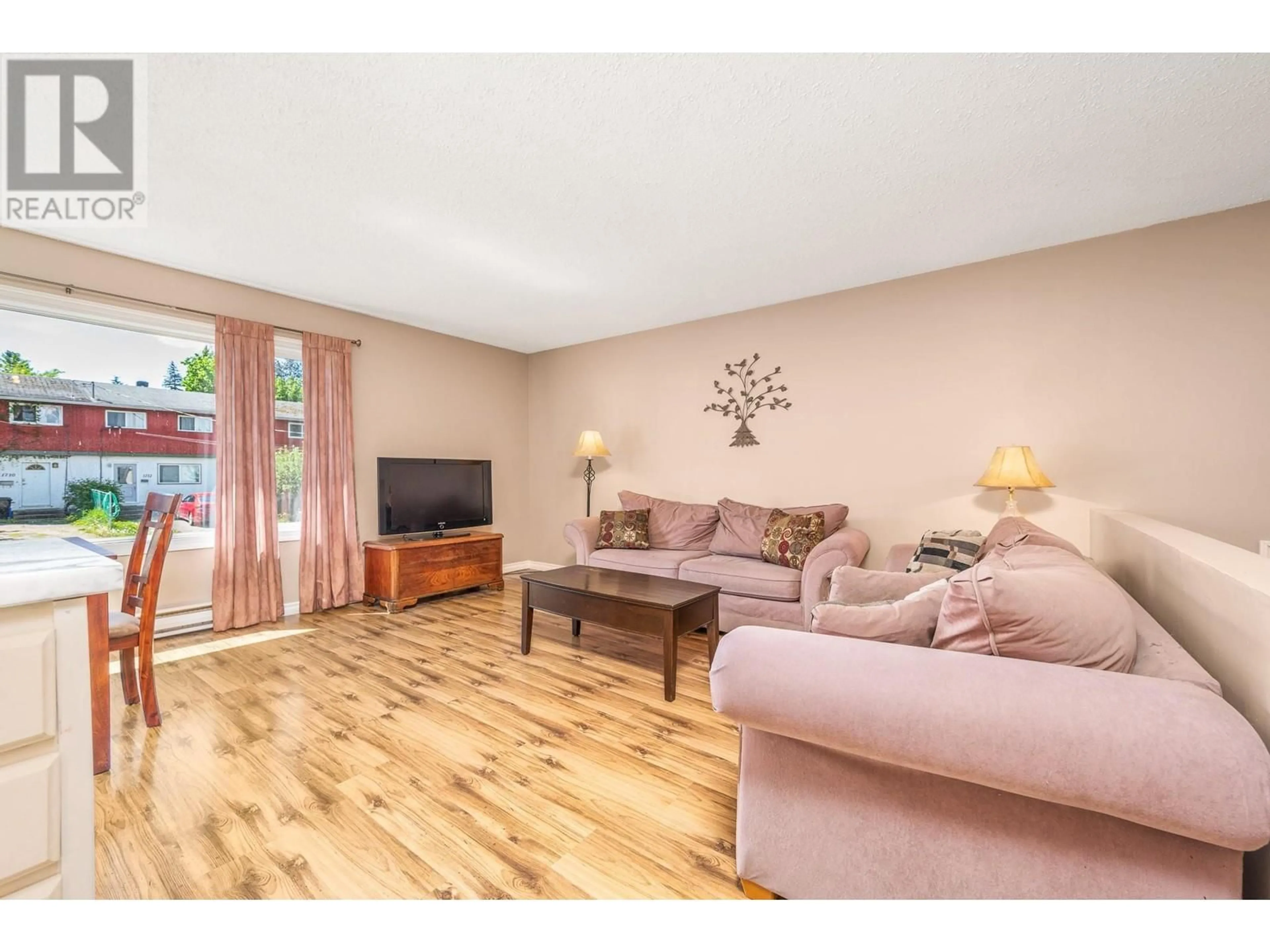 Living room with furniture, wood/laminate floor for 1711 41 AVENUE, Vernon British Columbia V1T7M8