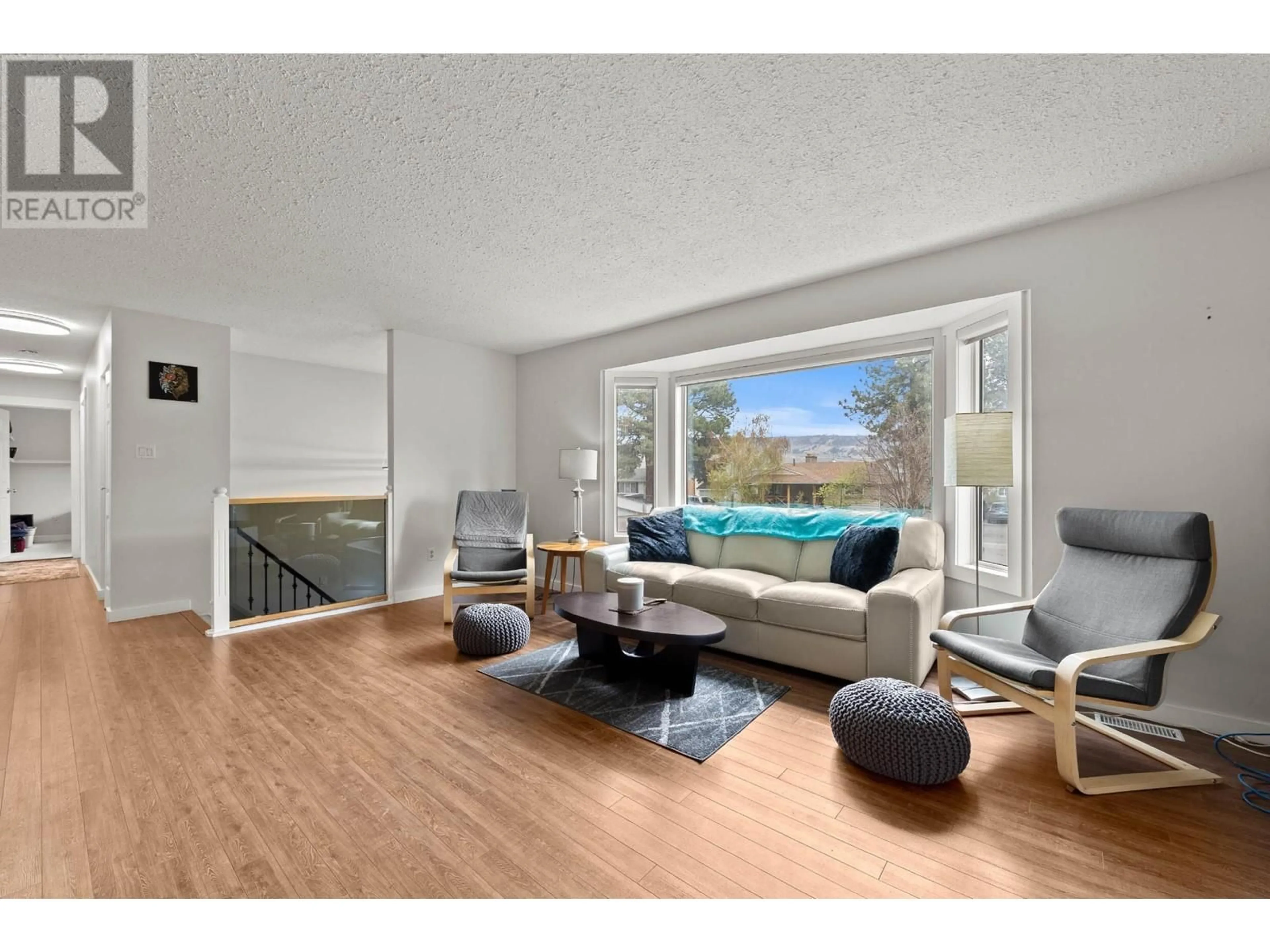 Living room with furniture, wood/laminate floor for 2613 IRVINE AVENUE, Merritt British Columbia V1K0B1