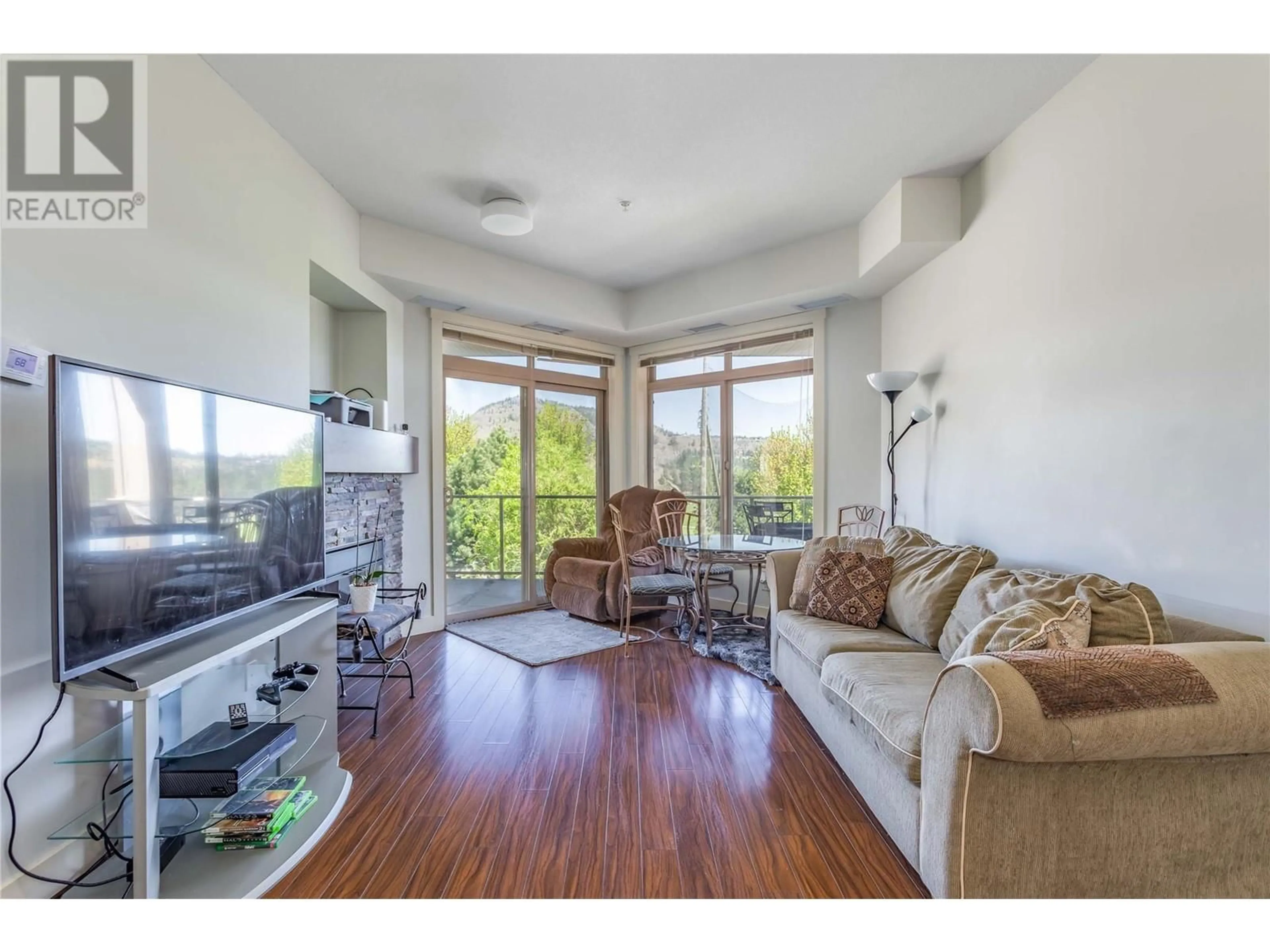 Living room with furniture, wood/laminate floor for 304 - 3533 CARRINGTON ROAD, West Kelowna British Columbia V4T2W6
