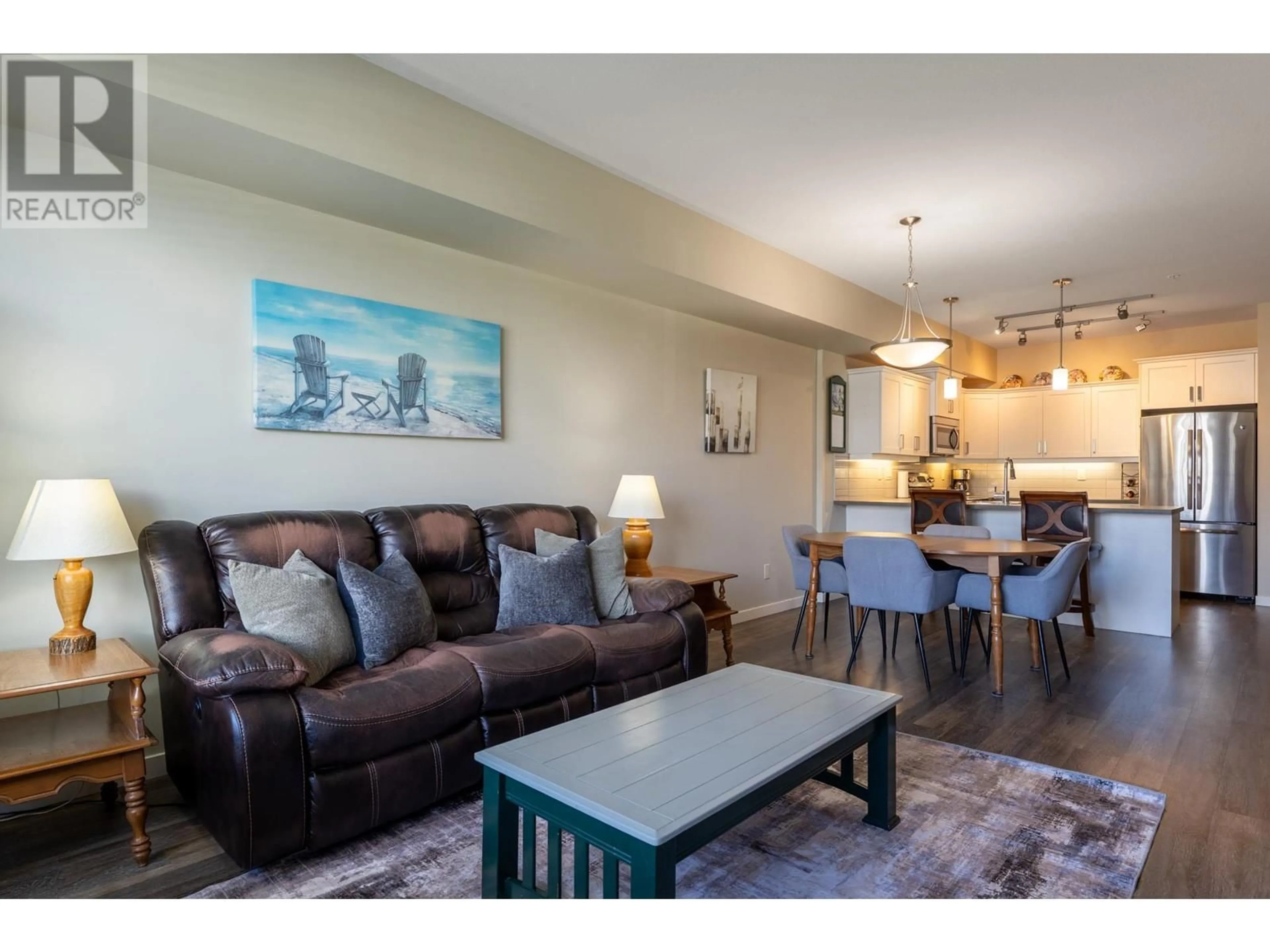Living room with furniture, wood/laminate floor for 211 - 3731 CASORSO ROAD, Kelowna British Columbia V1W5E9