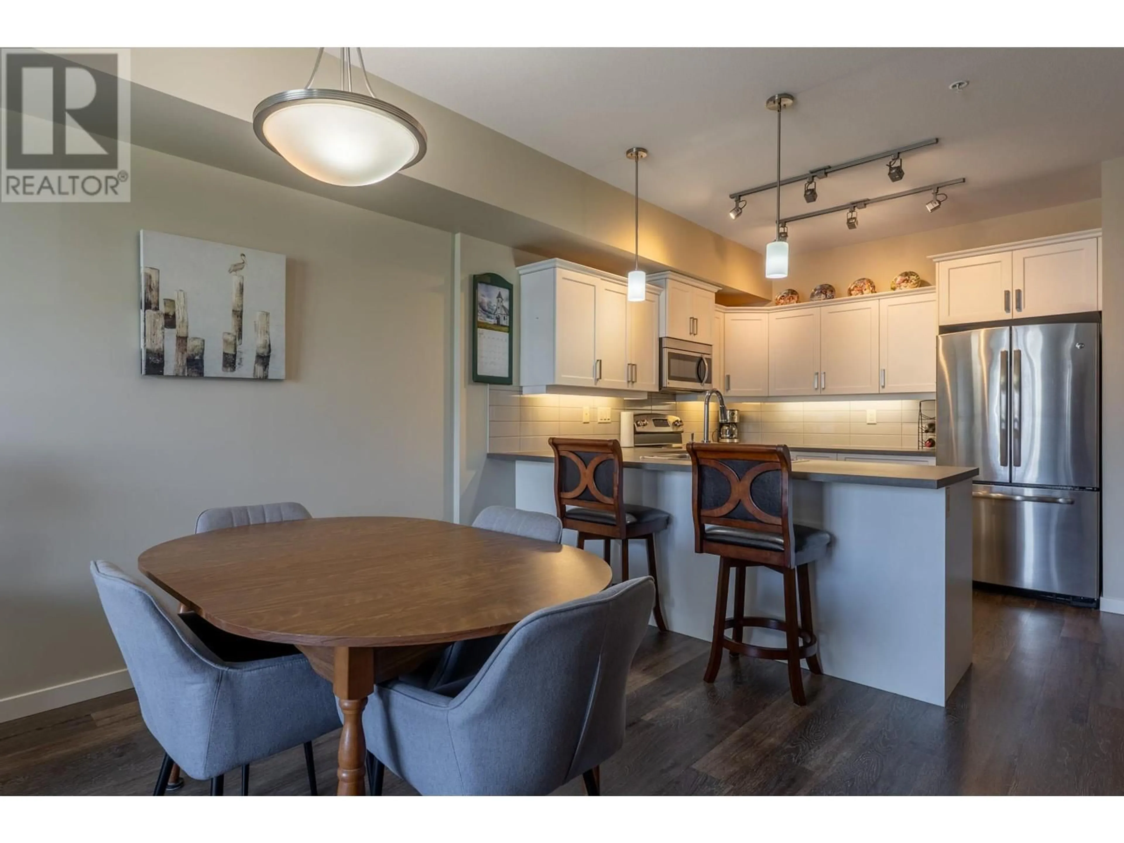 Open concept kitchen, wood/laminate floor for 211 - 3731 CASORSO ROAD, Kelowna British Columbia V1W5E9