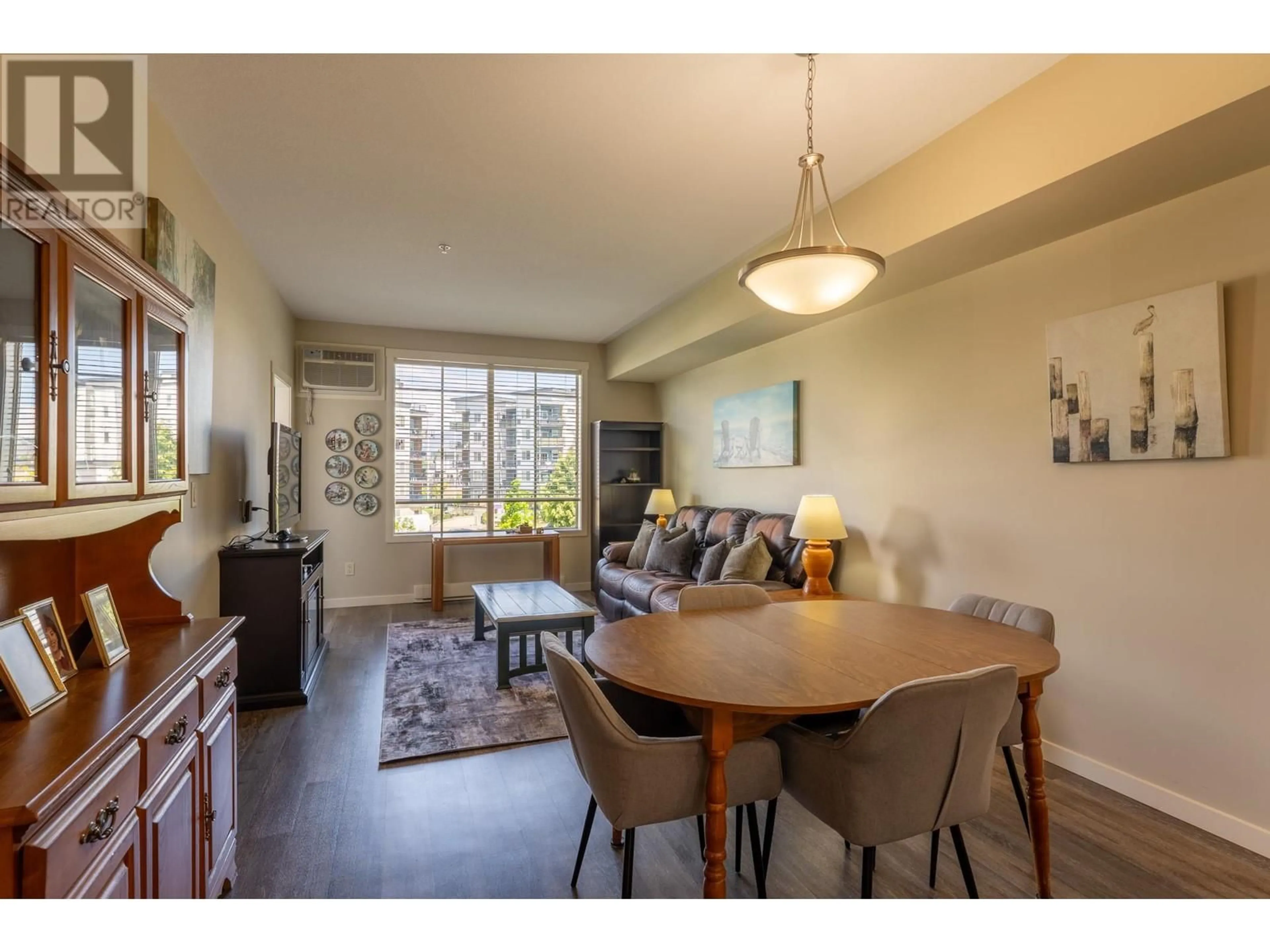 Living room with furniture, wood/laminate floor for 211 - 3731 CASORSO ROAD, Kelowna British Columbia V1W5E9