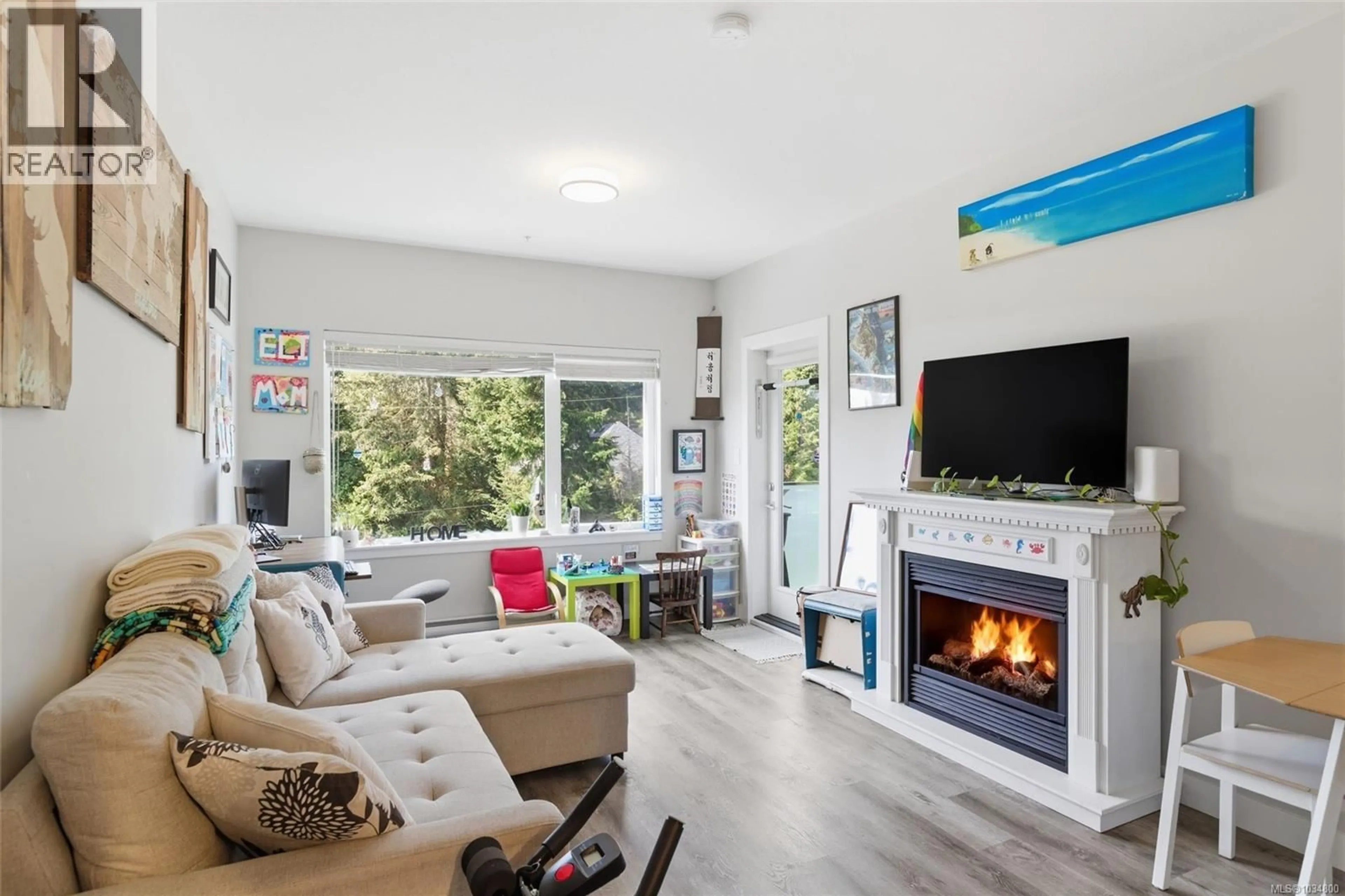 Living room with furniture, wood/laminate floor for 308 - 20 BARSBY AVENUE, Nanaimo British Columbia V9R0K4