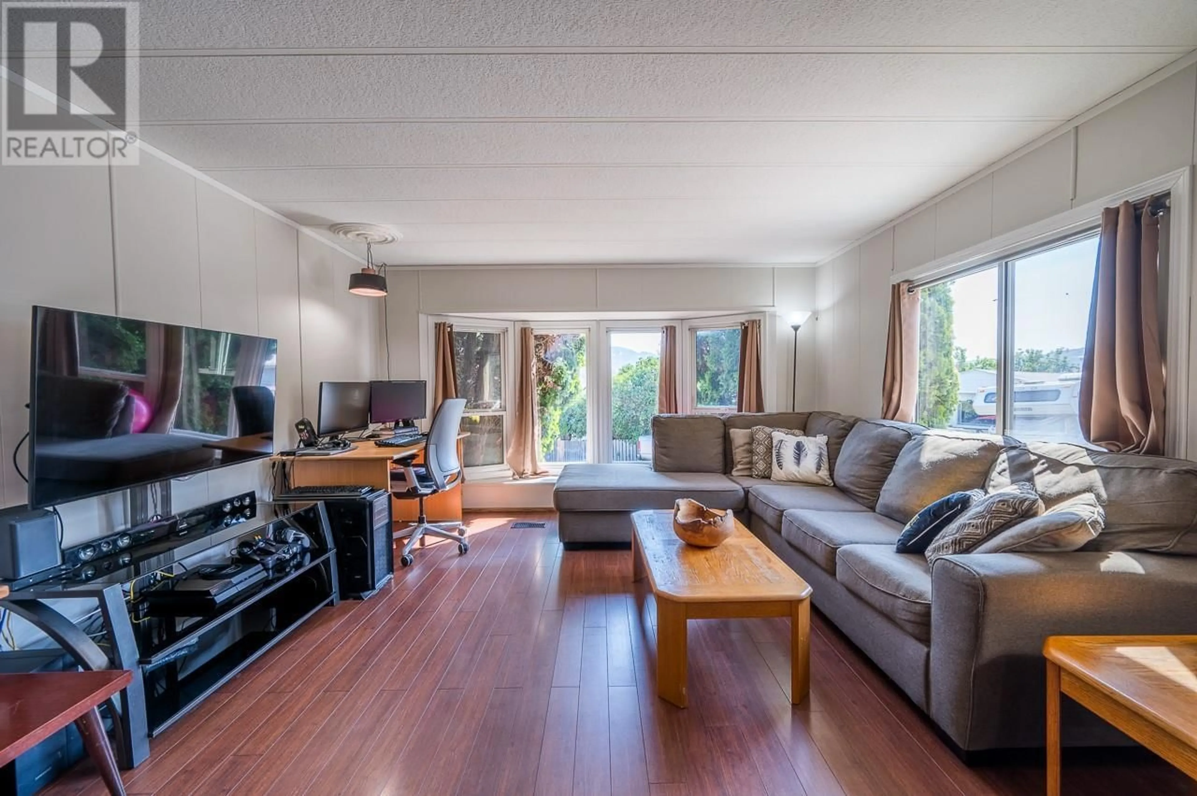 Living room with furniture, wood/laminate floor for C6 - 7155 DALLAS DRIVE, Kamloops British Columbia V2C4T1