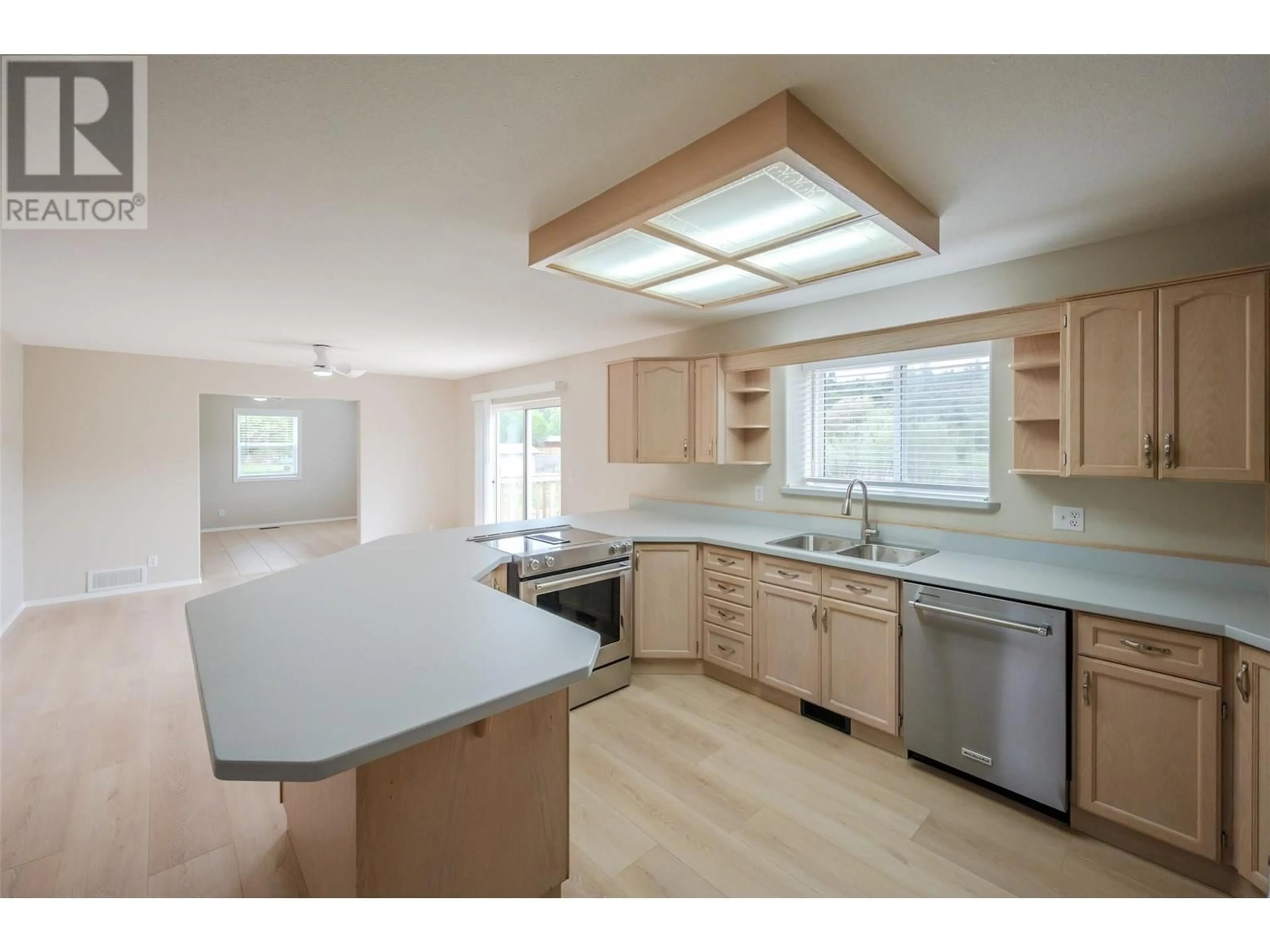 Open concept kitchen, wood/laminate floor for 5629 SAWMILL ROAD, Oliver British Columbia V0H1T9