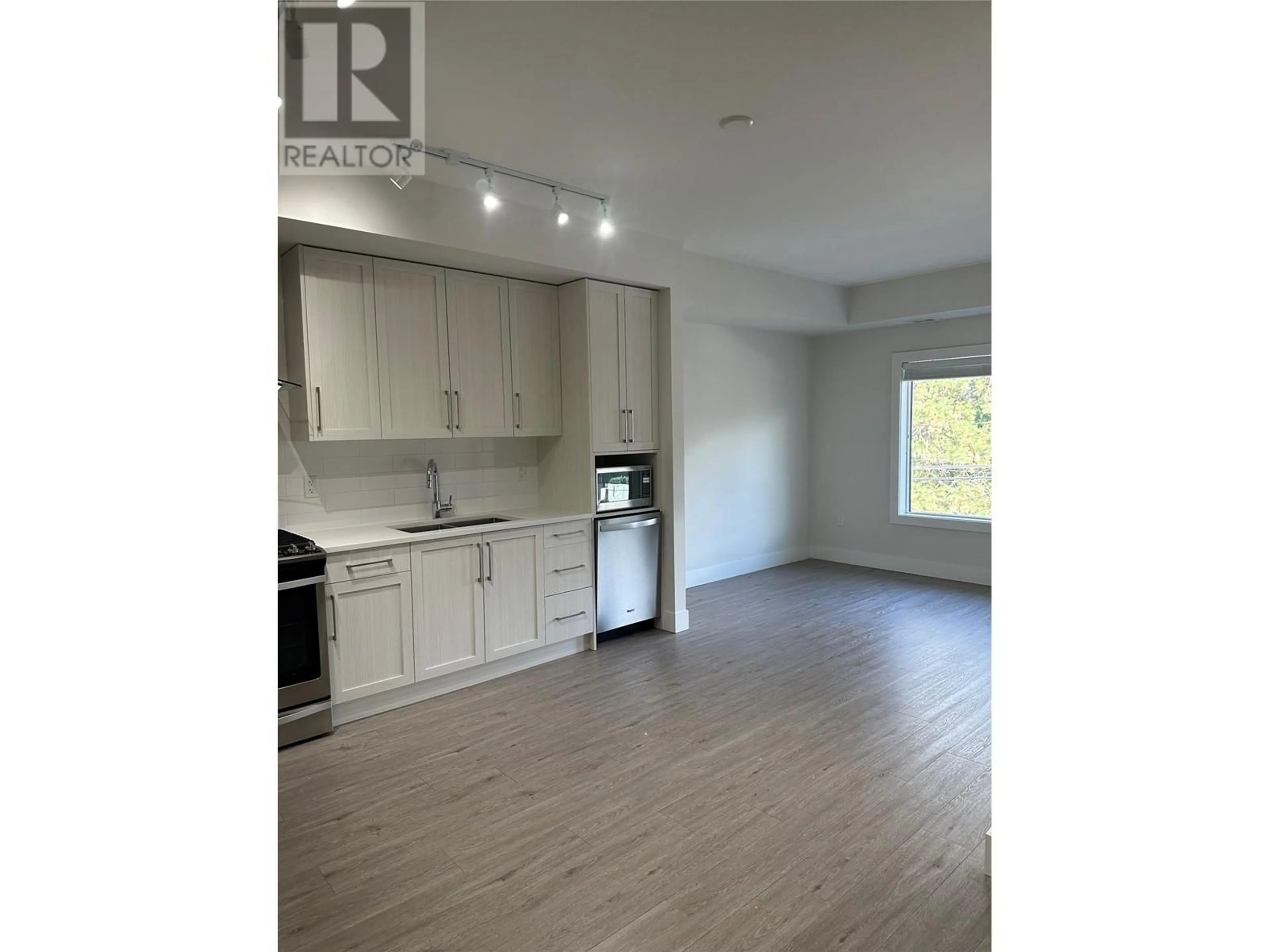 Open concept kitchen, wood/laminate floor for PH16 - 4380 LAKESHORE ROAD, Kelowna British Columbia V1Y0B5