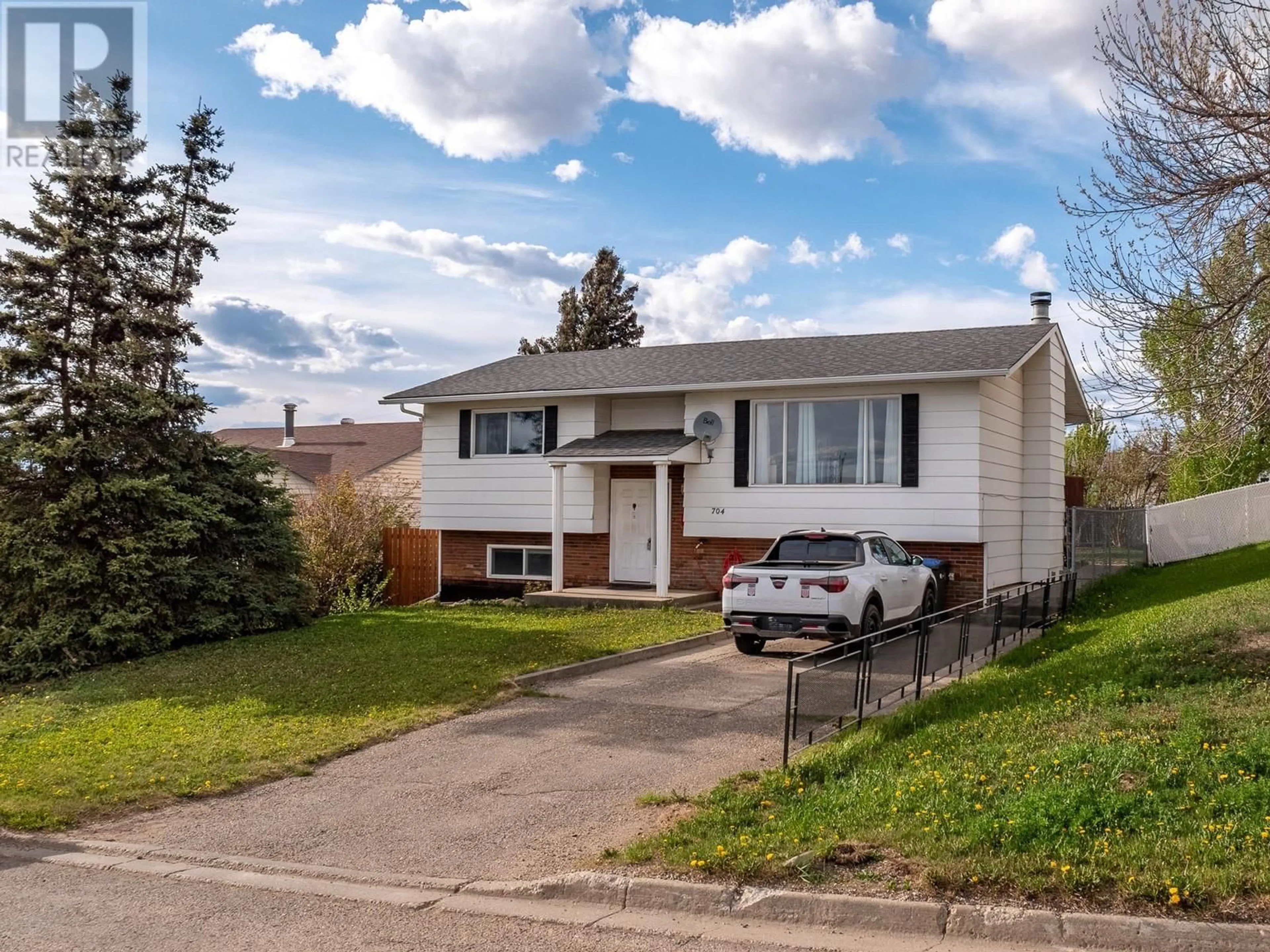Home with vinyl exterior material, street for 704 96A AVENUE, Dawson Creek British Columbia V1G1M7