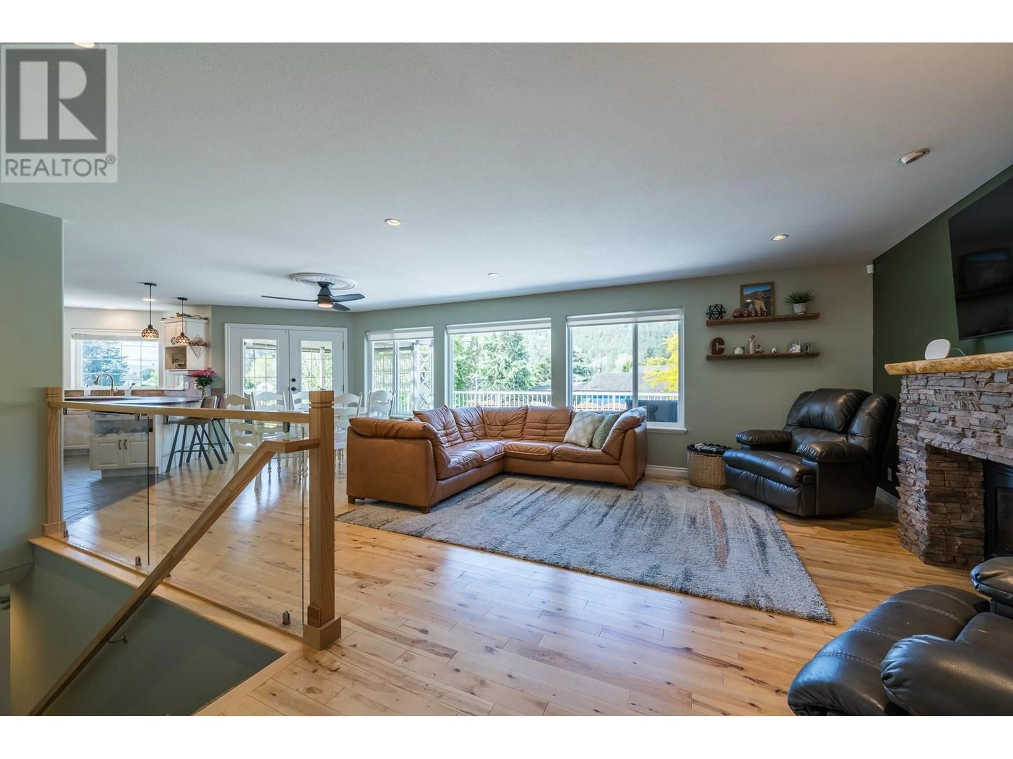 Living room with furniture, wood/laminate floor for 4705 SPURRAWAY ROAD, Kamloops British Columbia V2H1M6