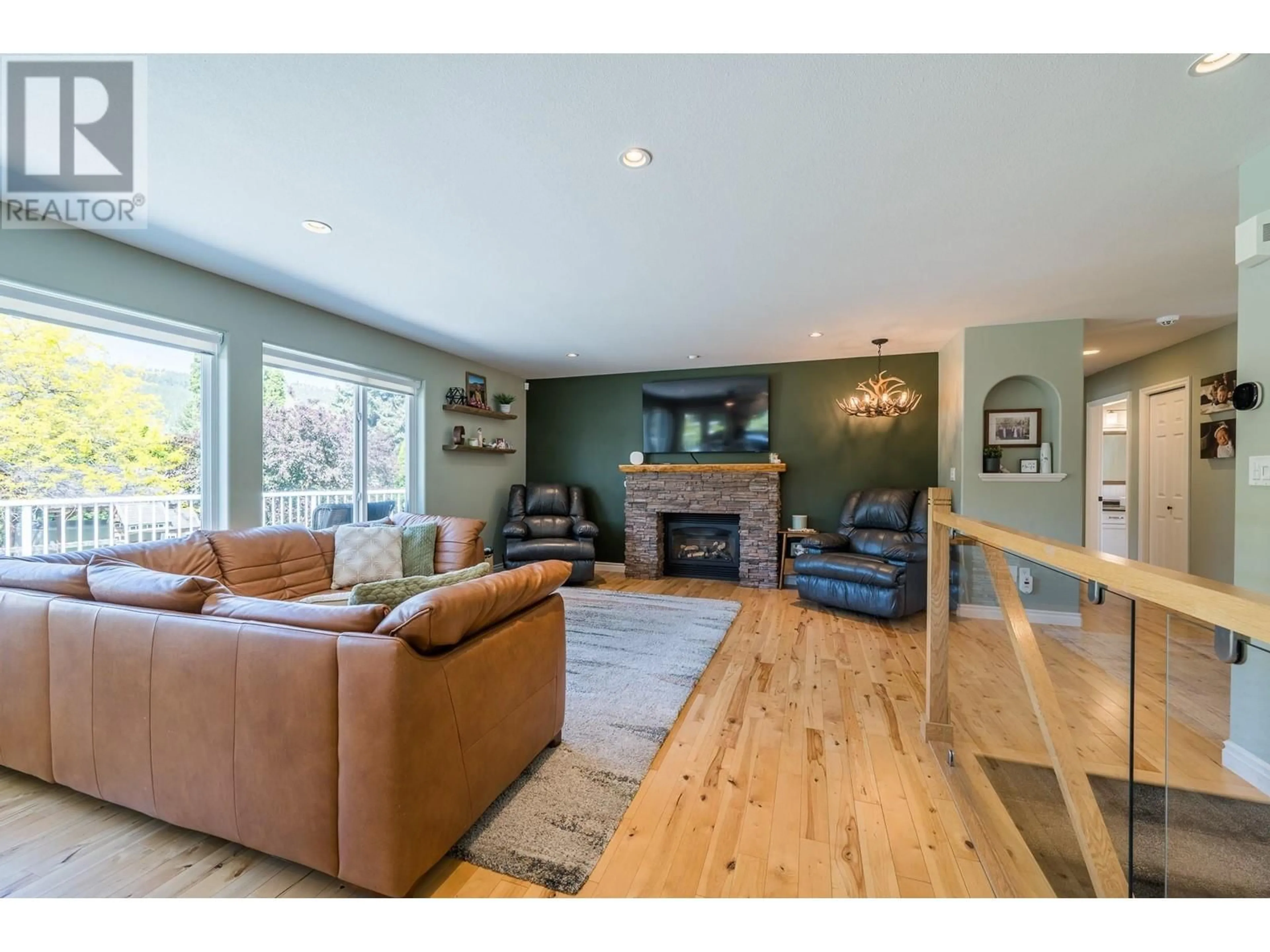 Living room with furniture, wood/laminate floor for 4705 SPURRAWAY ROAD, Kamloops British Columbia V2H1M6