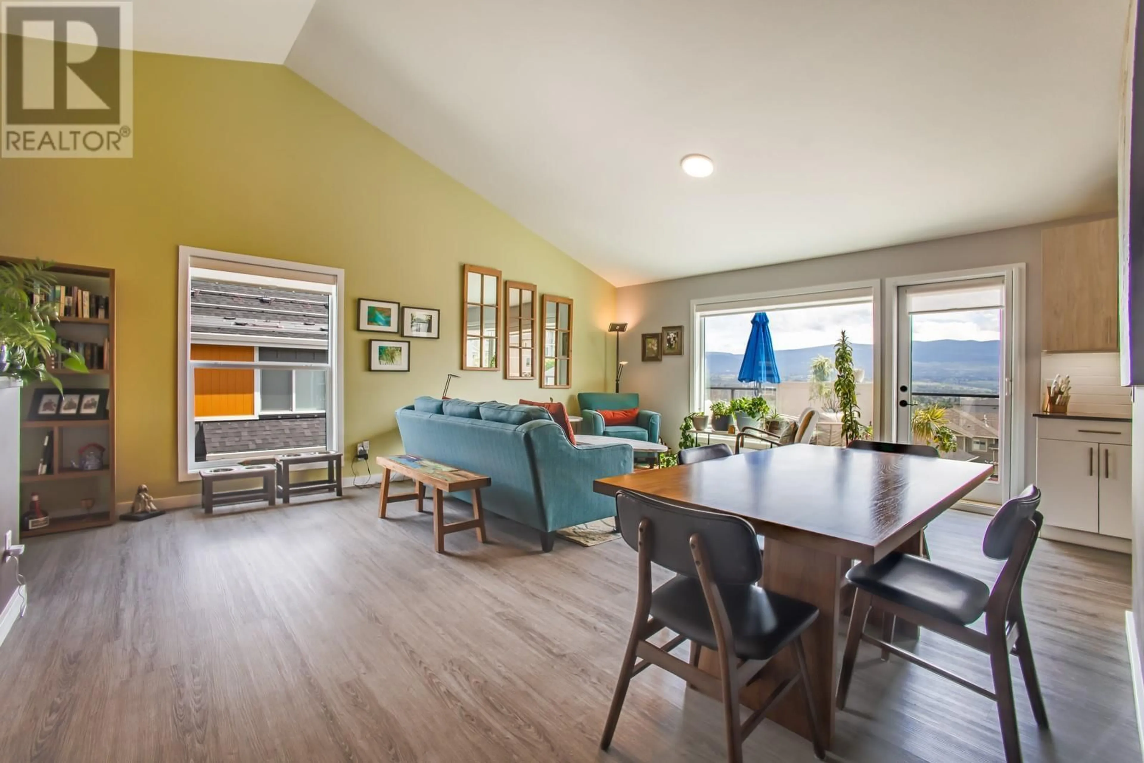 Living room with furniture, wood/laminate floor for 70 - 685 BOYNTON PLACE, Kelowna British Columbia V1V0G7