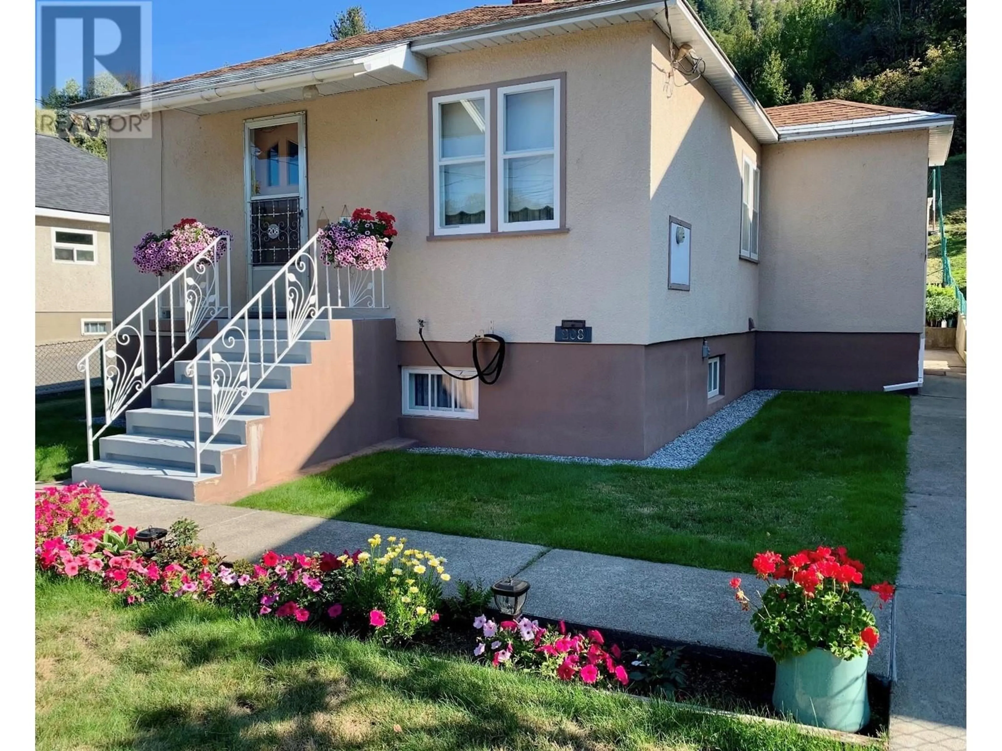 Home with vinyl exterior material, street for 208 HAIG STREET, Warfield British Columbia V1R2L9