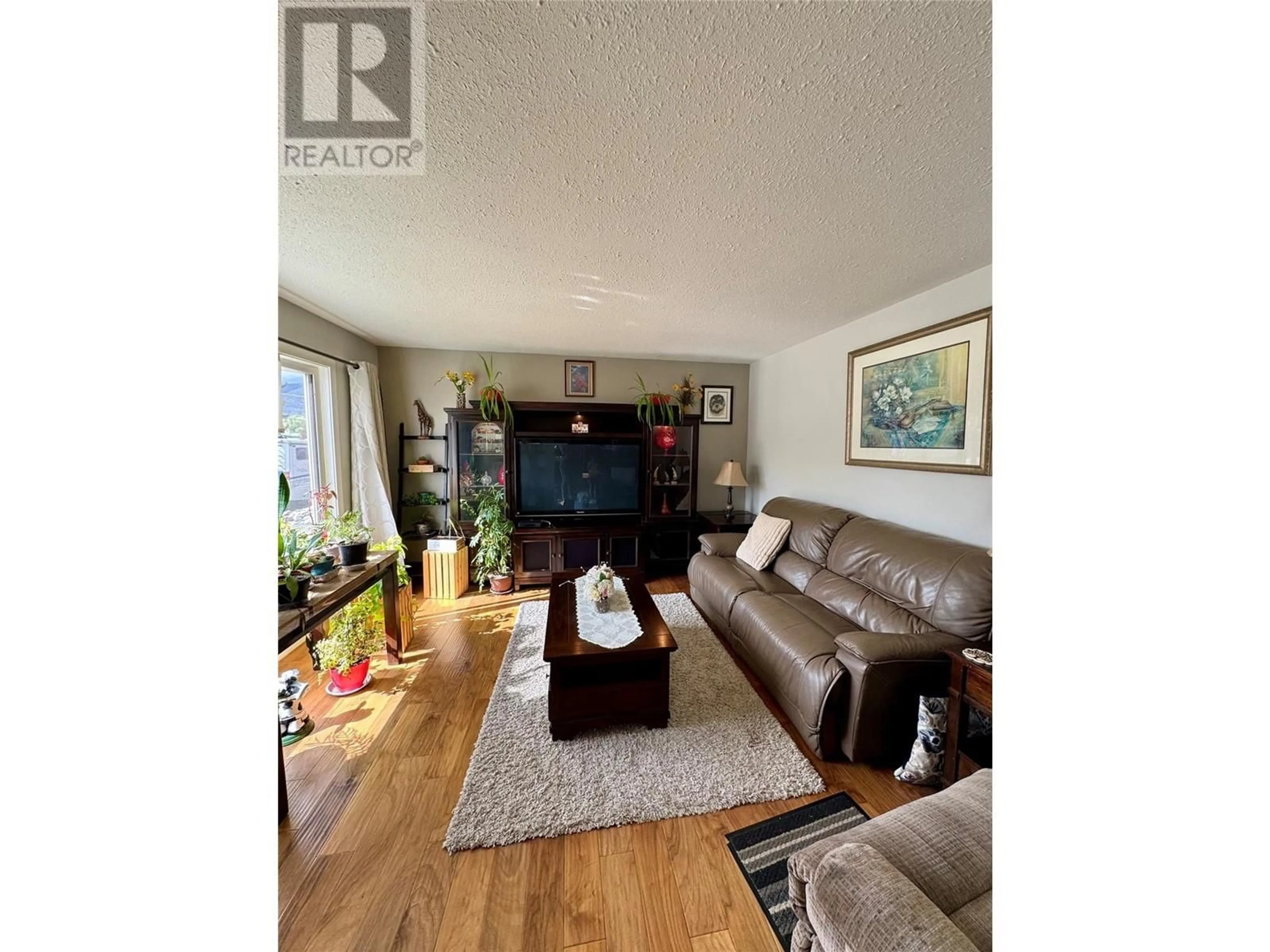 Living room with furniture, wood/laminate floor for 1740 ARMSTRONG STREET, Merritt British Columbia V1K1E7