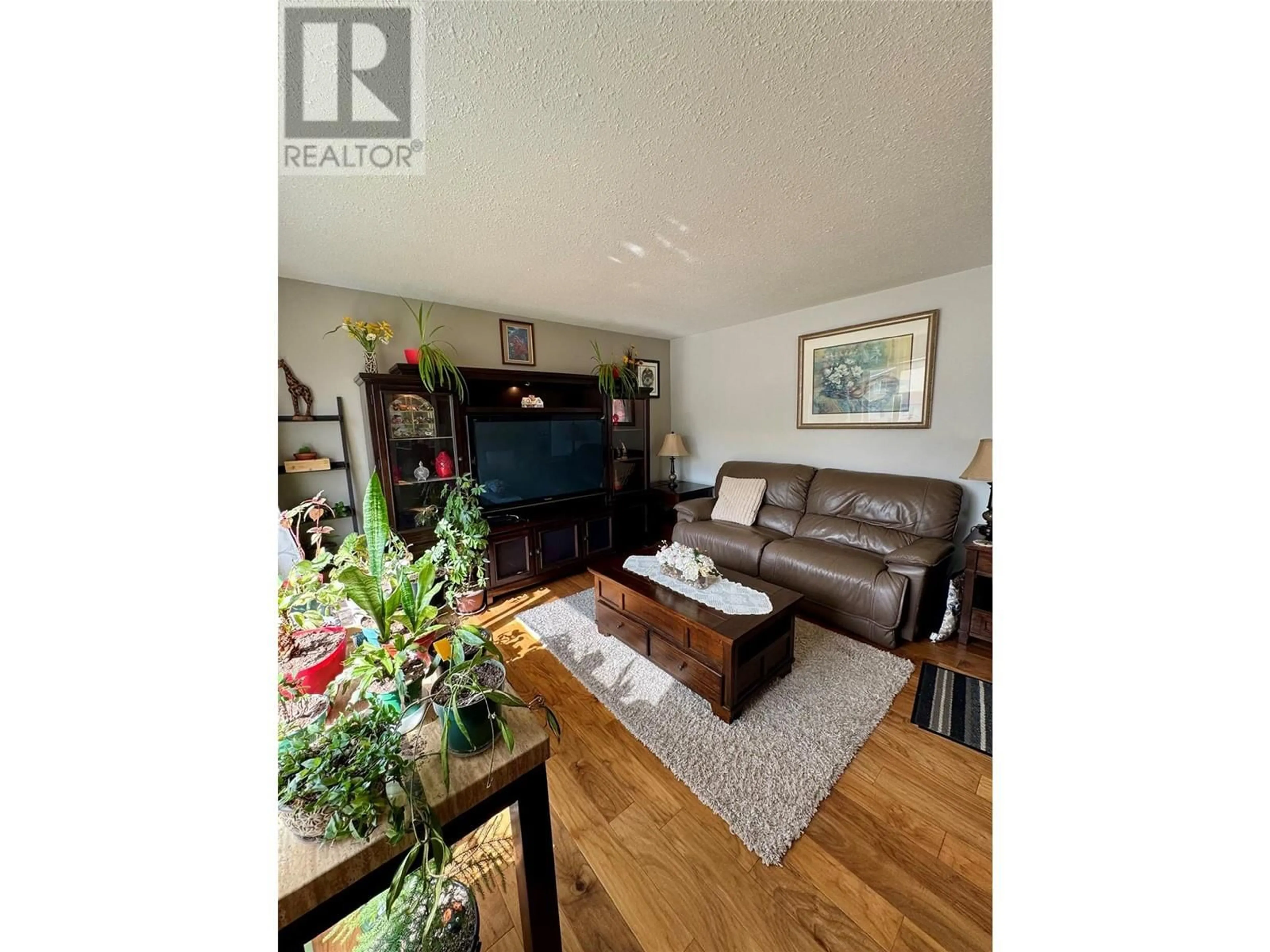Living room with furniture, wood/laminate floor for 1740 ARMSTRONG STREET, Merritt British Columbia V1K1E7