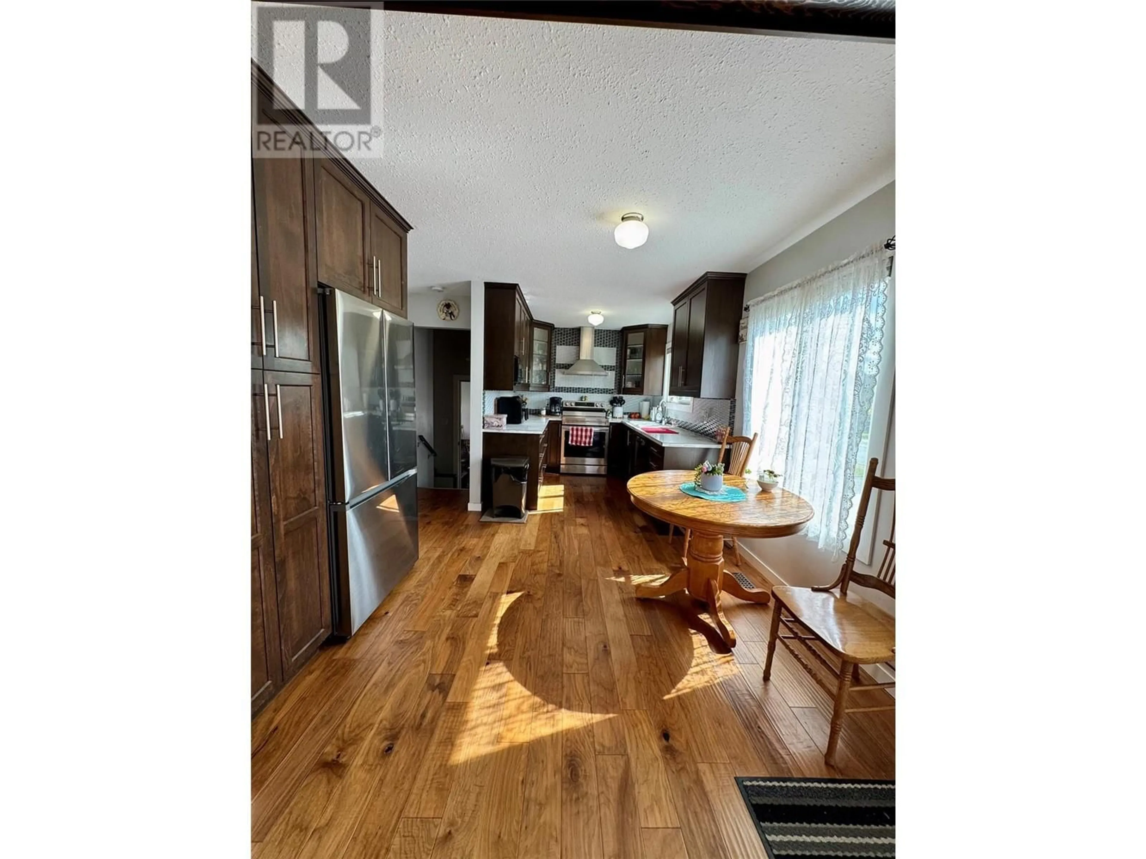 Open concept kitchen, wood/laminate floor for 1740 ARMSTRONG STREET, Merritt British Columbia V1K1E7