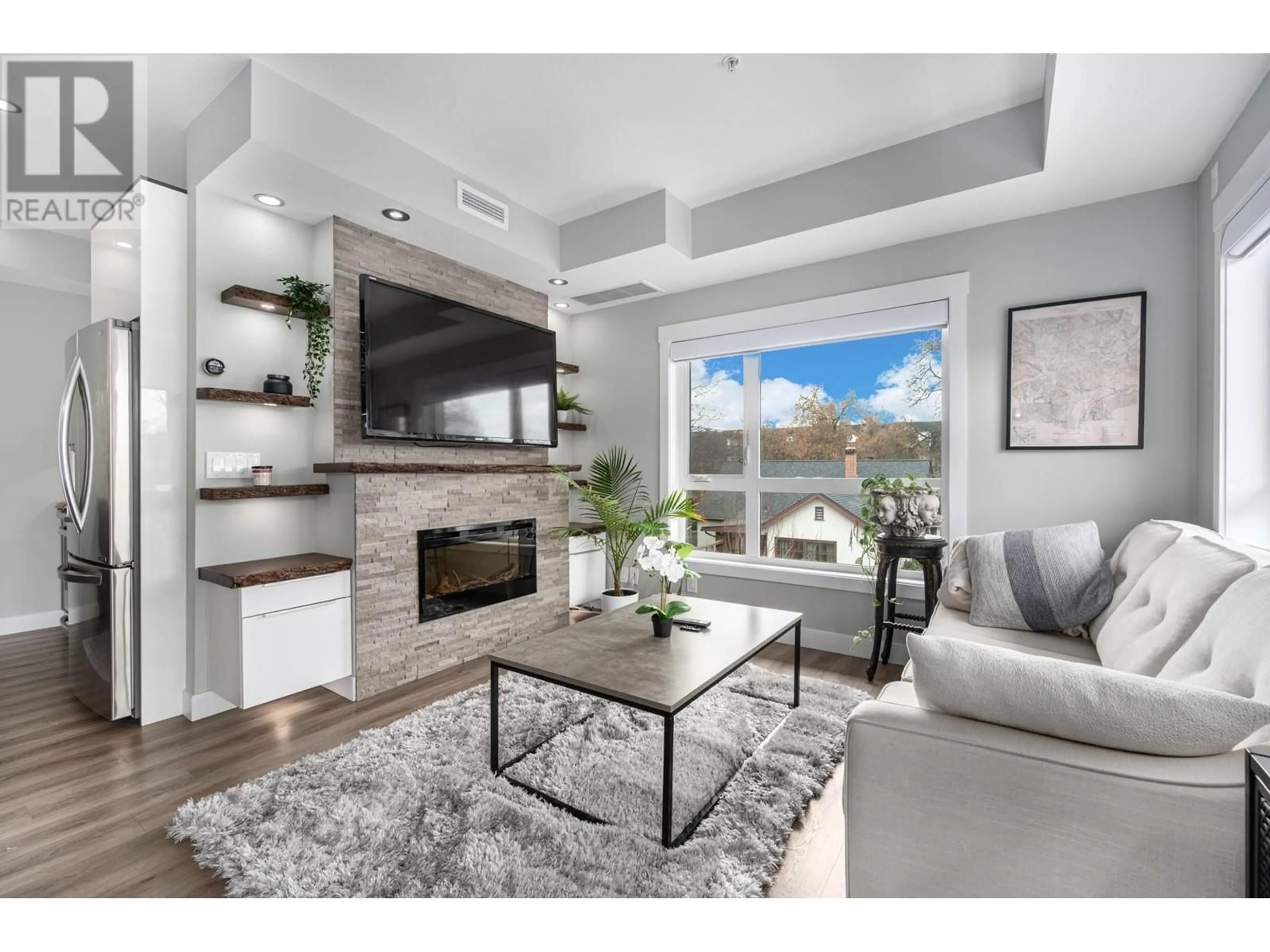 Living room with furniture, wood/laminate floor for 201 - 1883 WATER STREET, Kelowna British Columbia V1Y1K4
