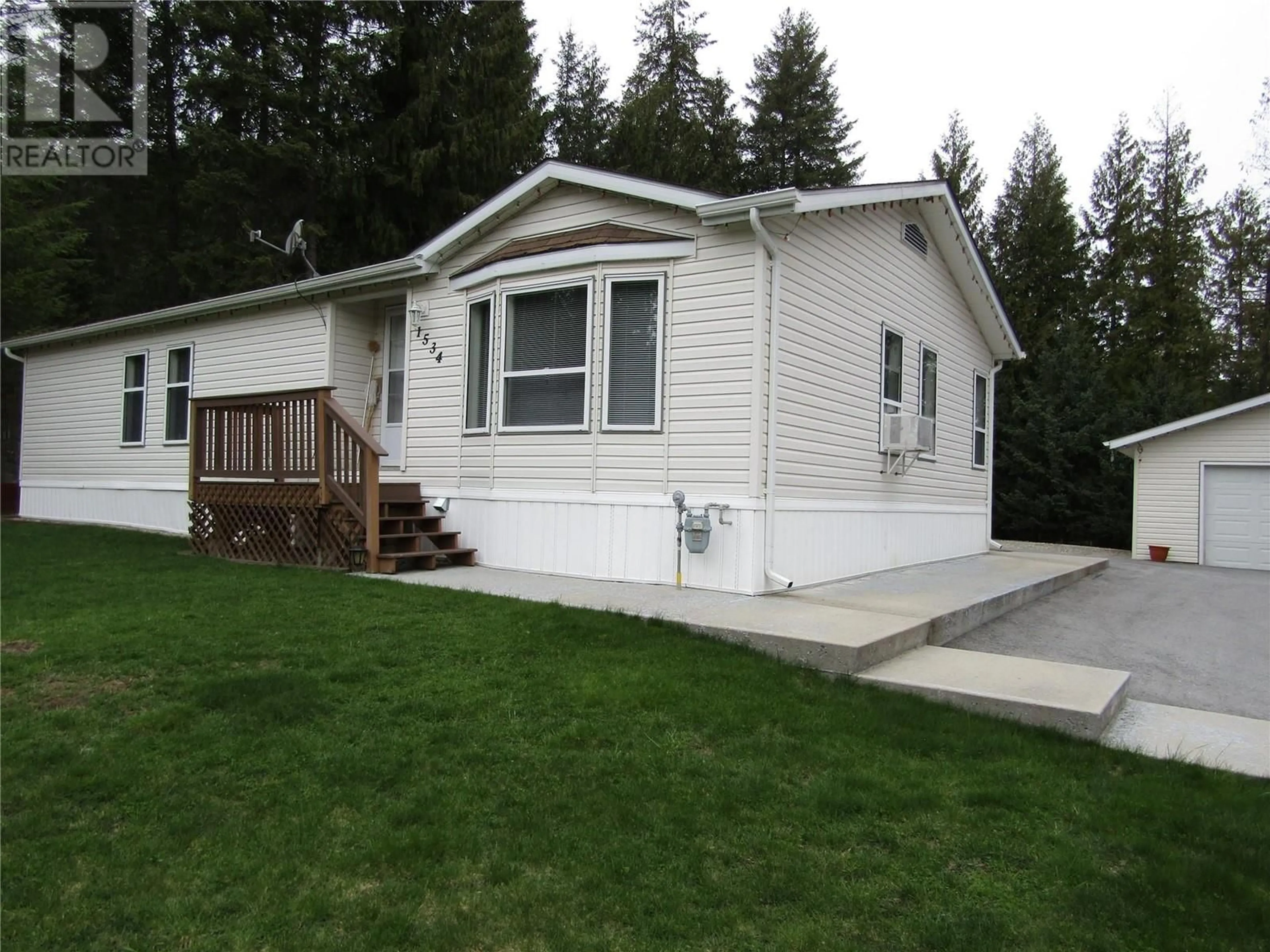 Home with vinyl exterior material, street for 1534 MCINTYRE ROAD, Christina Lake British Columbia V0H1E0