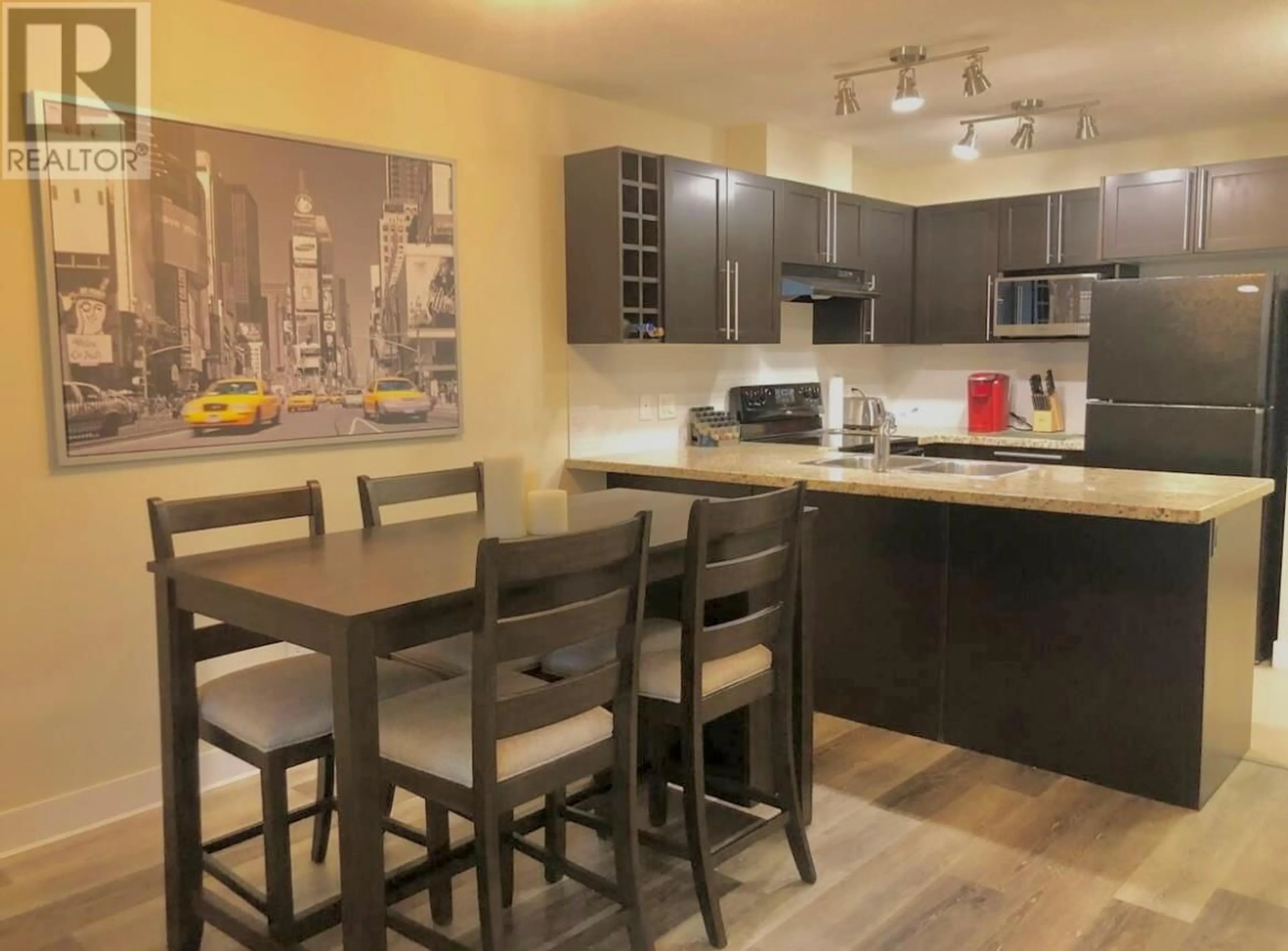 Open concept kitchen, wood/laminate floor for 102 - 1089 SUNSET DRIVE, Kelowna British Columbia V1Y9Z3