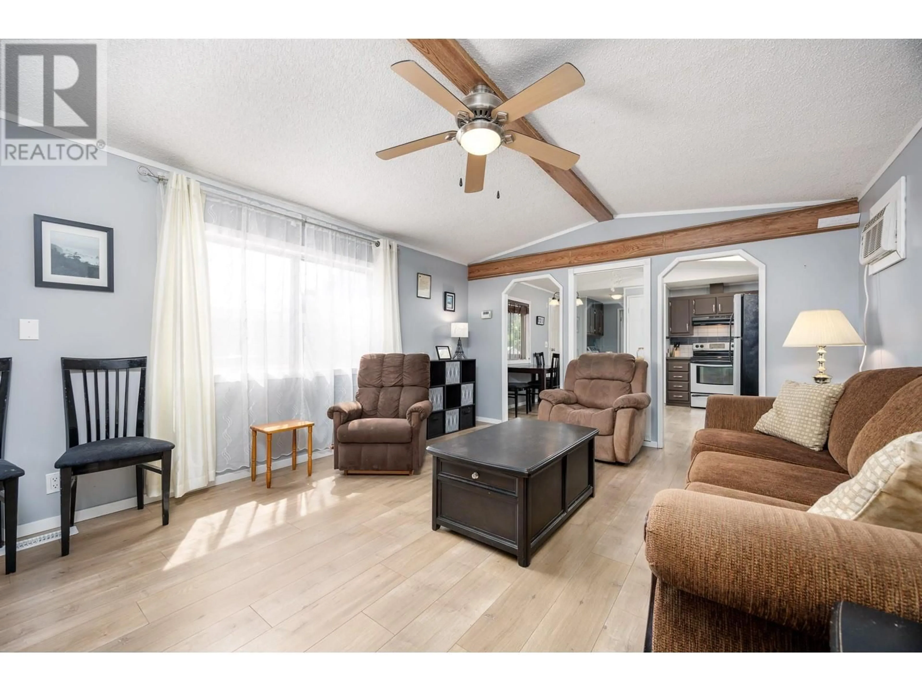 Living room with furniture, wood/laminate floor for 24 - 2001 HIGHWAY 97 STREET, West Kelowna British Columbia V1Z3E3